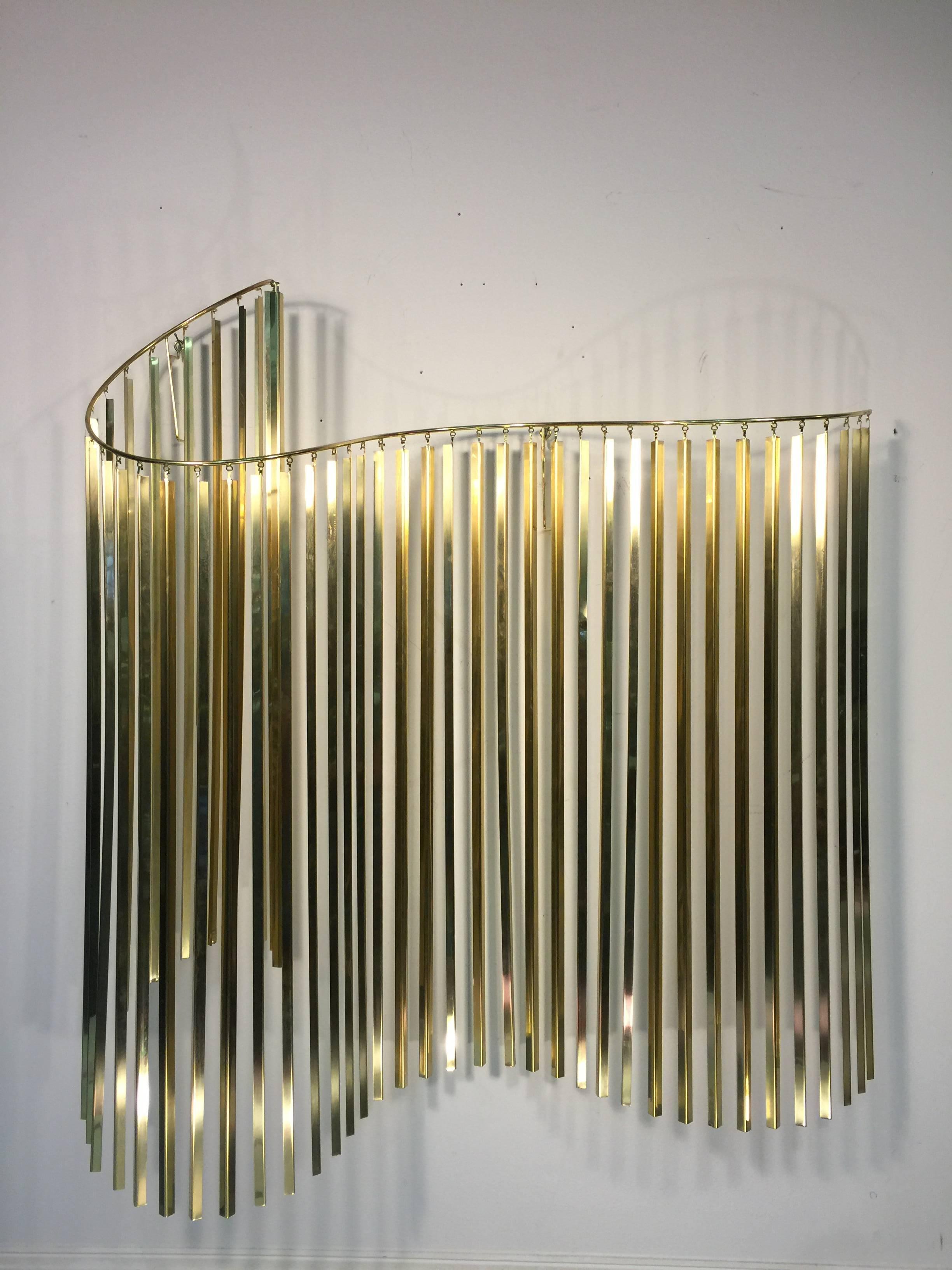 A wonderful Kinetic wave form wall sculpture in brass and chrome signed C. Jere, and dated 1985.