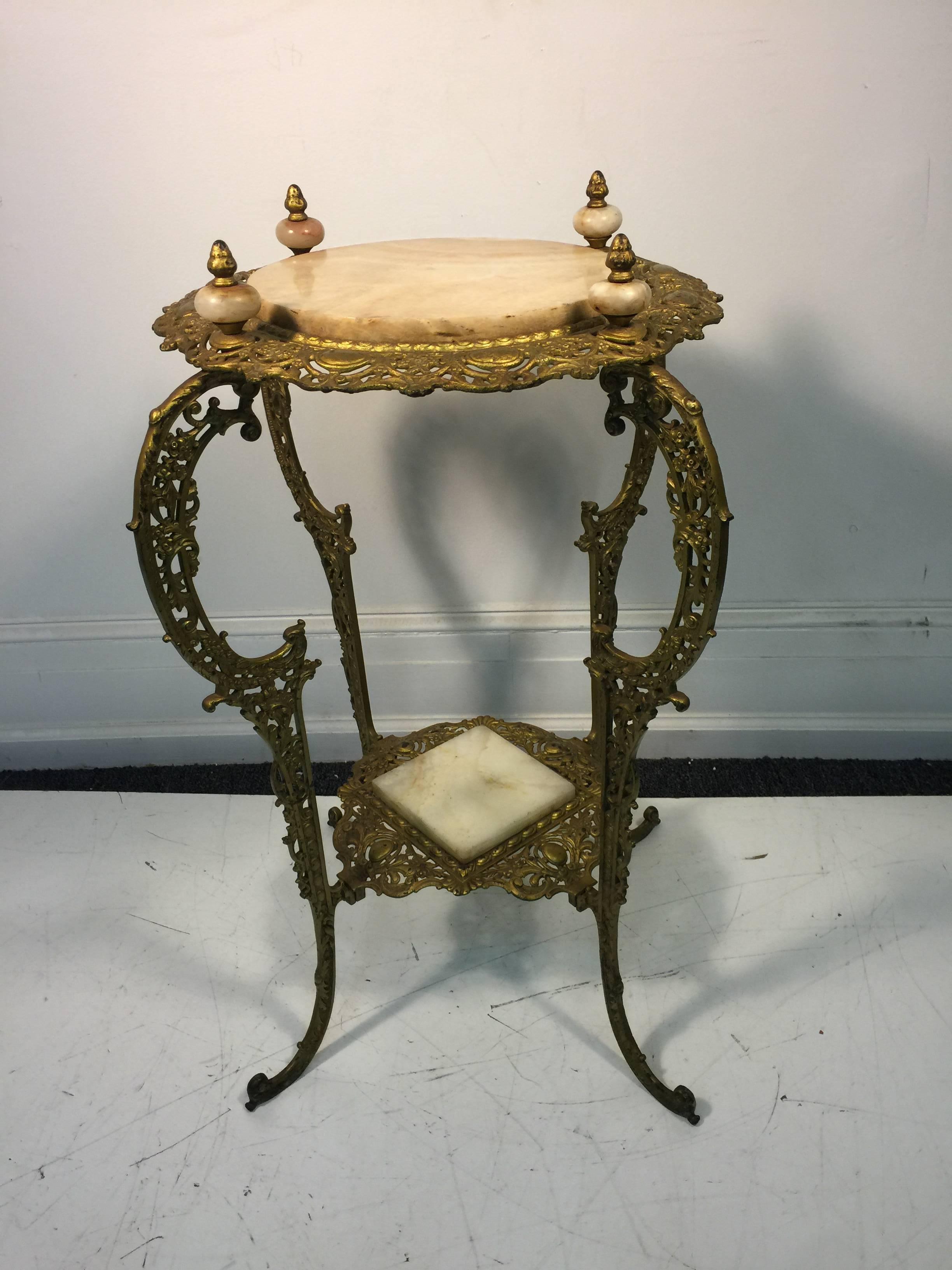 An amazing Art Nouveau two-tier onyx and gilded iron pant stand, circa 1910.