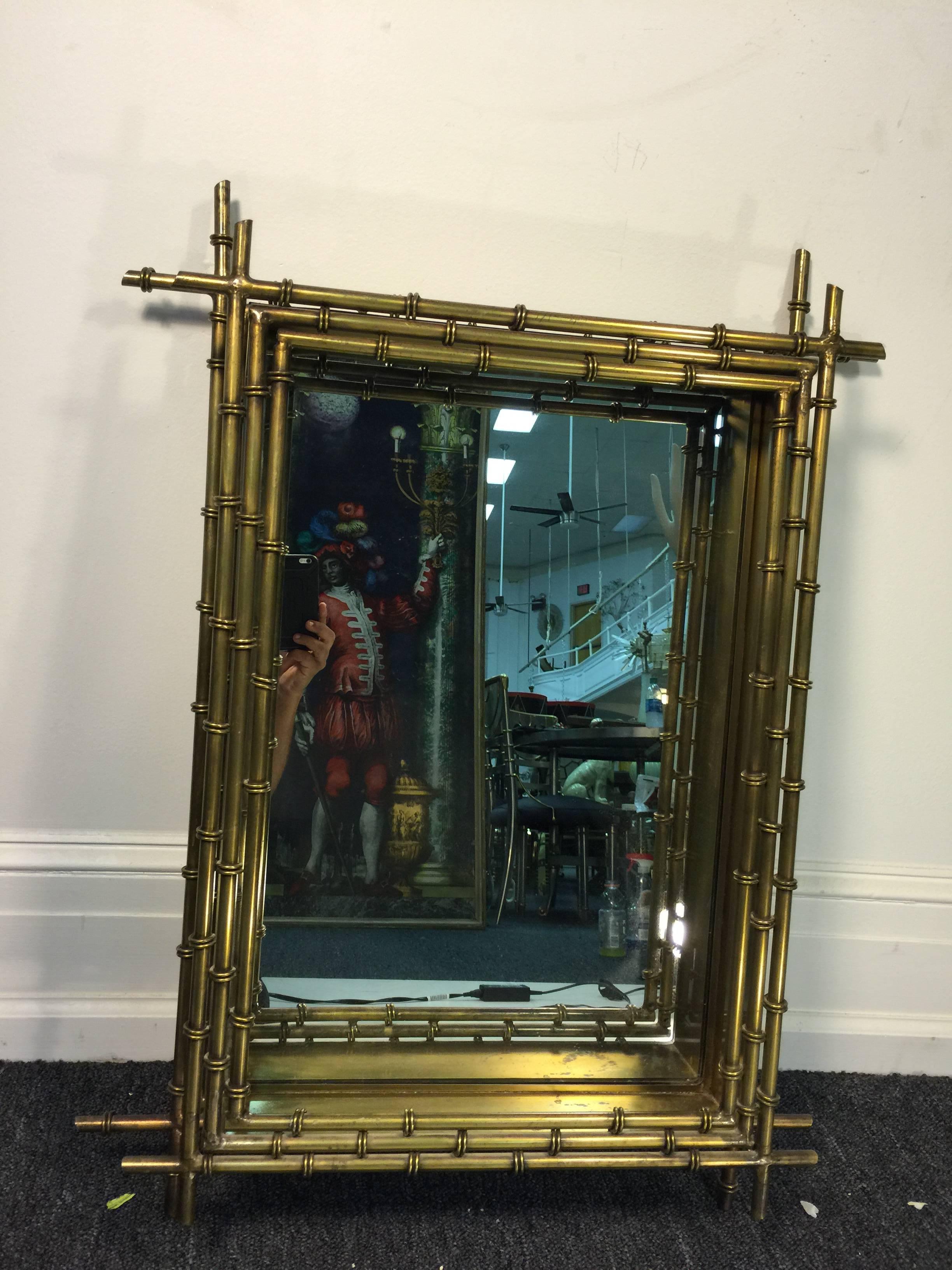 A fantastic brass bamboo modernist wall mirror signed C. Jere, circa 1970. Inset in a Shadowbox Form ,Very Substantial and designed with Great Structure this Mirror would Highlight any Great Modern Console it was placed above.A  Perfect Mirror that