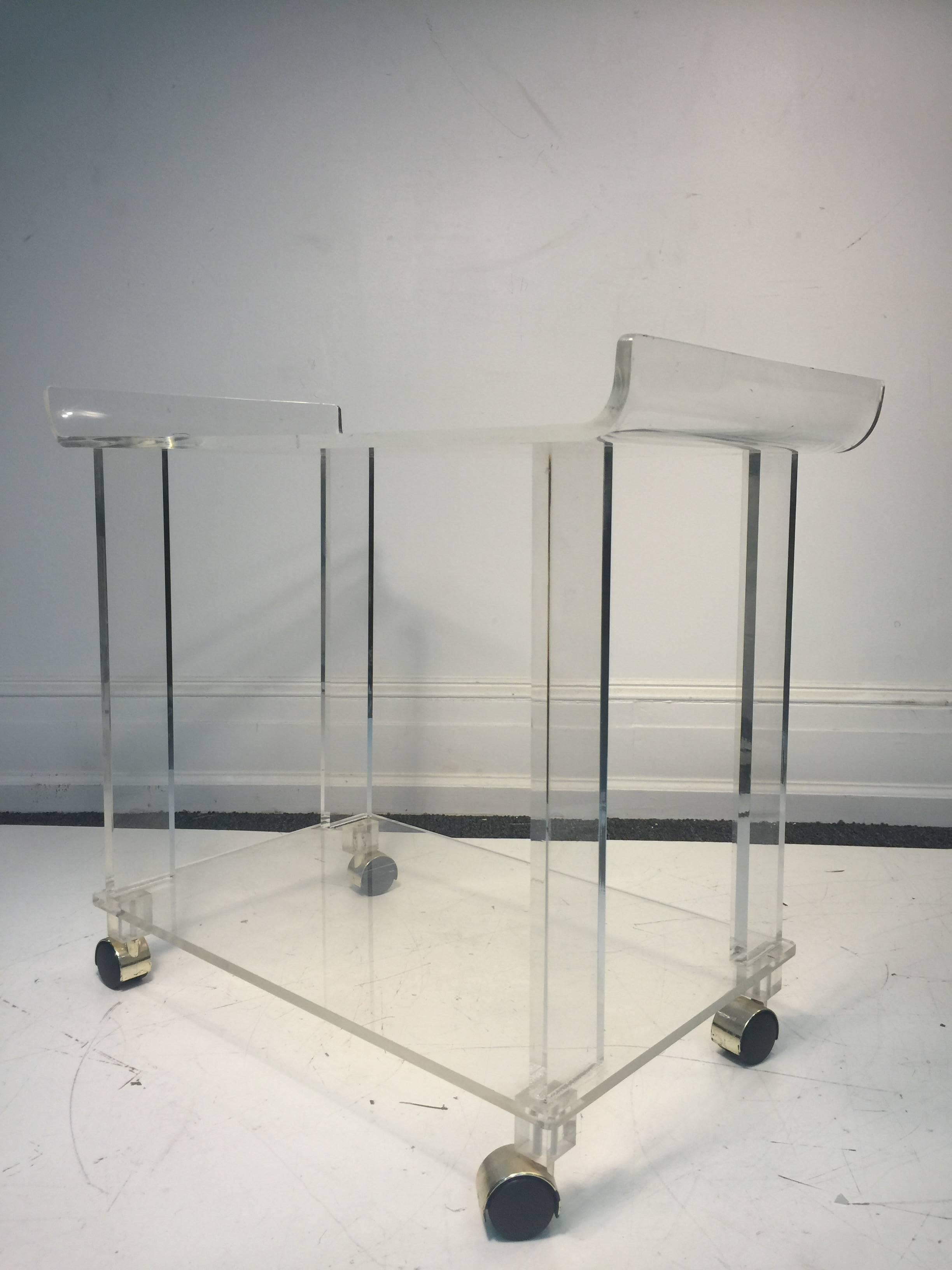 A terrific, modern, two-tier Lucite tea cart on casters, circa 1970. Wear appropriate with age.