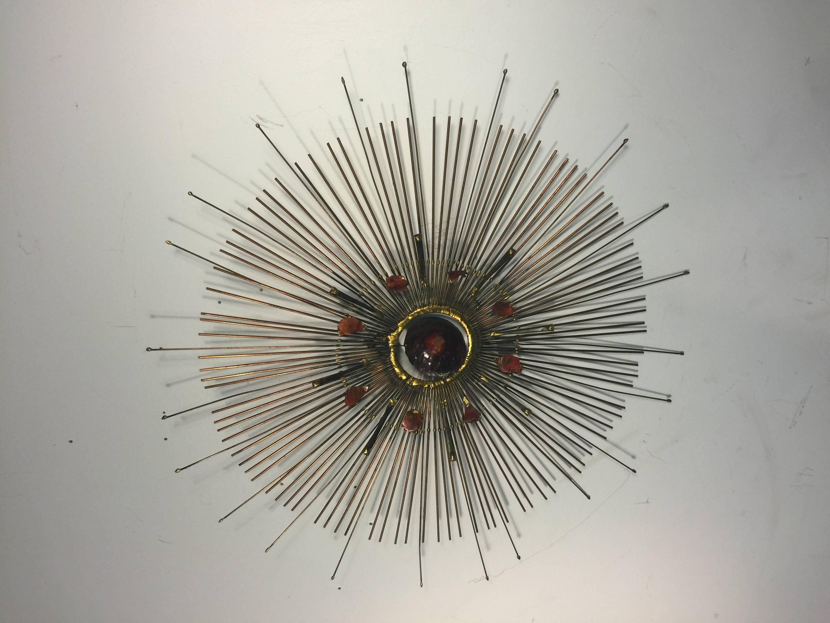 A beautiful Curtis Jere mixed-metal sunburst wall-mounted sculpture with colorful removable center, circa 1970.