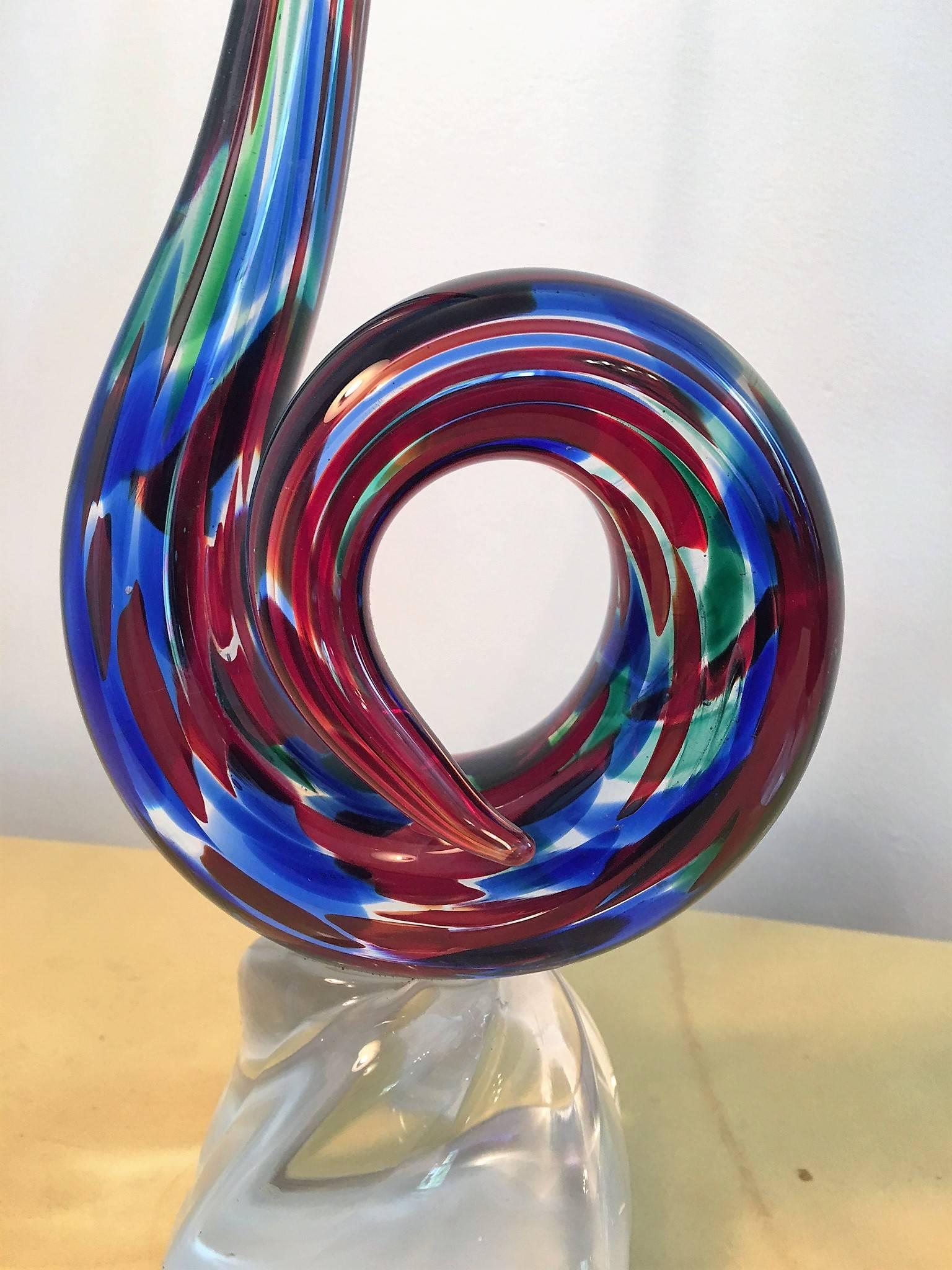 Great modernistic handblown Murano sculptures in perfect condition in the hues used by Italian glass master Fulvio Bianconi the rich jewel tones of blue, red and green set within a clear glass background. Mounted on solid clear glass bases these are
