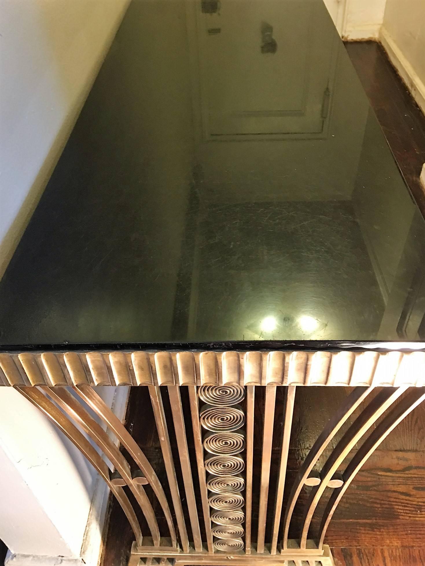 Exceedingly Rare Solid Bronze designed Console table with all the aspects of a Museum Quality period art deco piece. Fabricated of solid bronze with a Black Glass Vitrolite Top this console made by French Art Deco Master Artist Edgar Brandt. Solid 