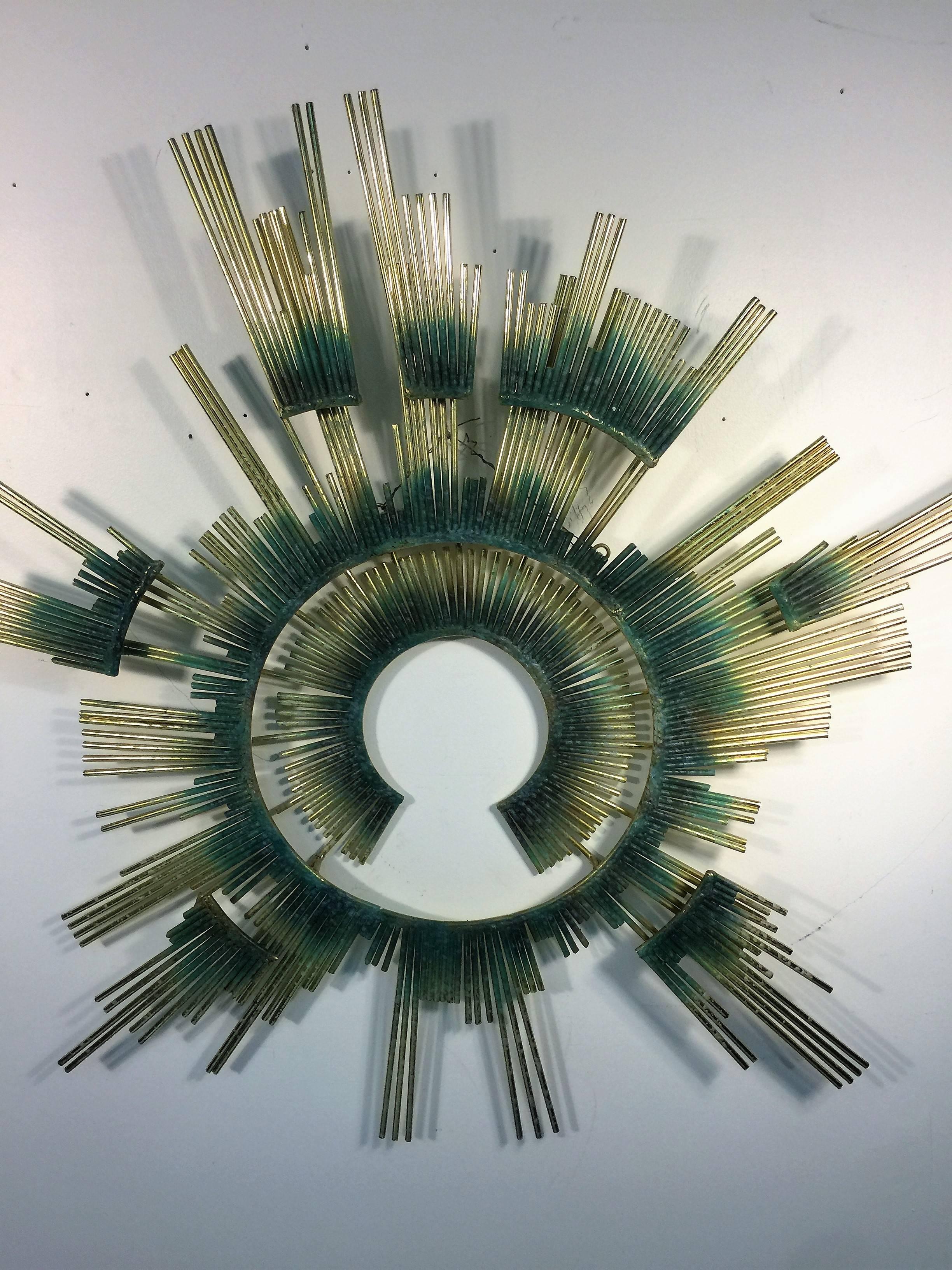 Exceptional and well constructed sunburst wall sculpture signed C Jere 1987.
With many hooks to hang this is a great modern wall sculpture that would create depth and drama to your interior.