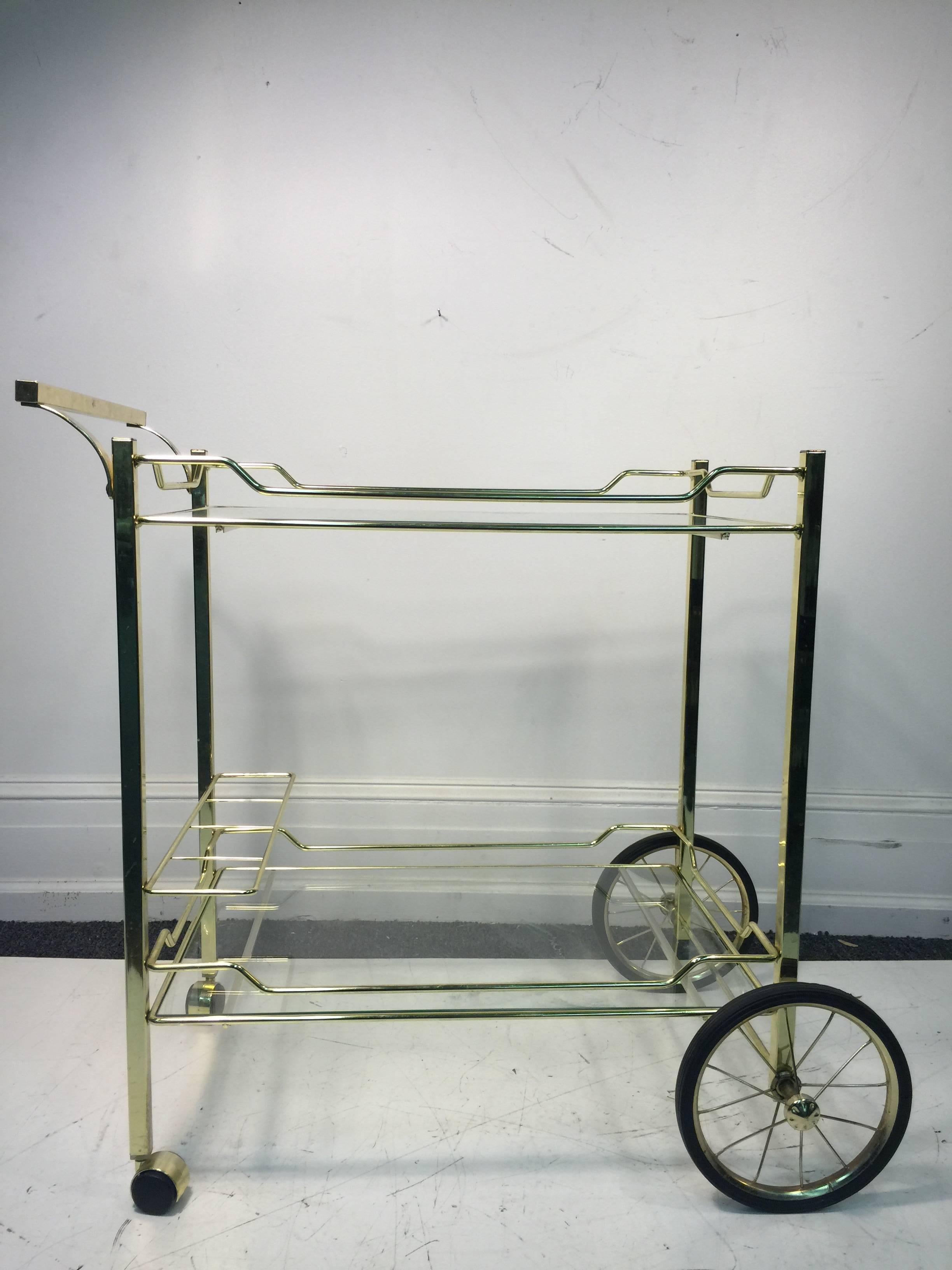 A beautiful, brass and glass, vintage, bar or tea cart made for the Design Institute of America (DIA), circa 1970.