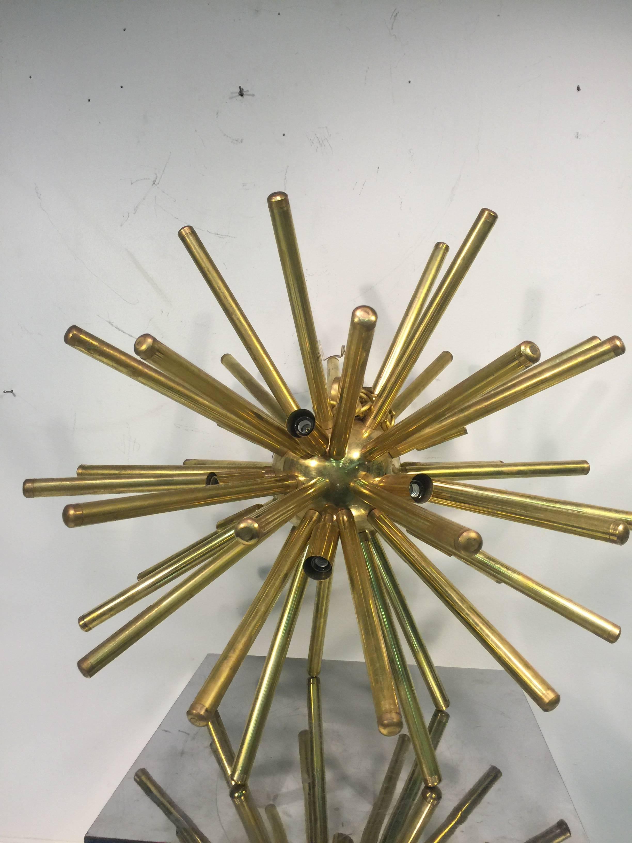 A stunning pair of Sputnik chandeliers with substantial, tubular, brass rods, circa 1990. Good condition with age appropriate wear. Adjustable chain.