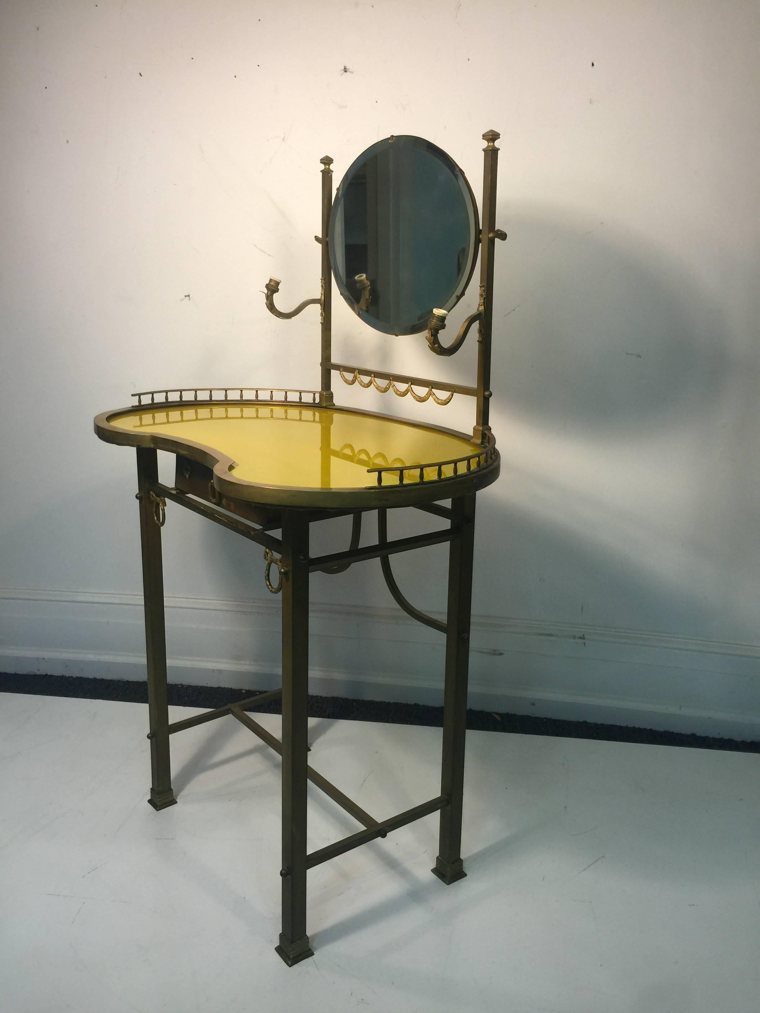 An exquisite 19th century French, bronze vanity with hand-painted yellow glass top and brass accents. Highly decorative with great attention to detail. Good condition with age appropriate wear.