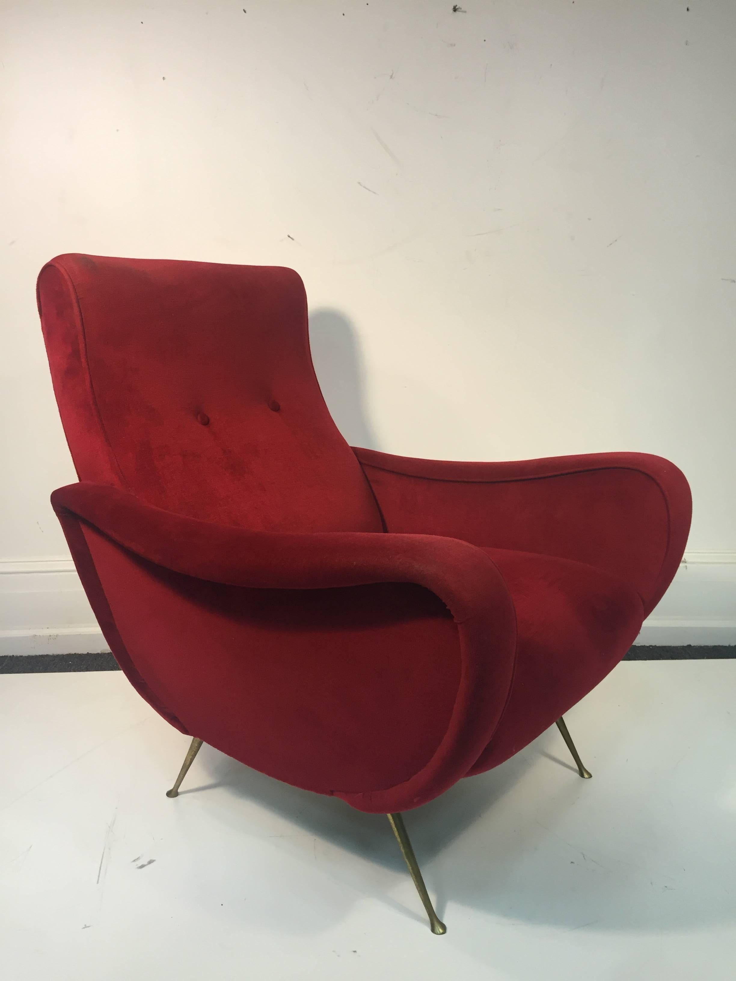 A marvelous pair of button tufted, burgundy, Marco Zanuso style Italian lounge chairs with brass legs, circa 1970. Some wear to the fabric.