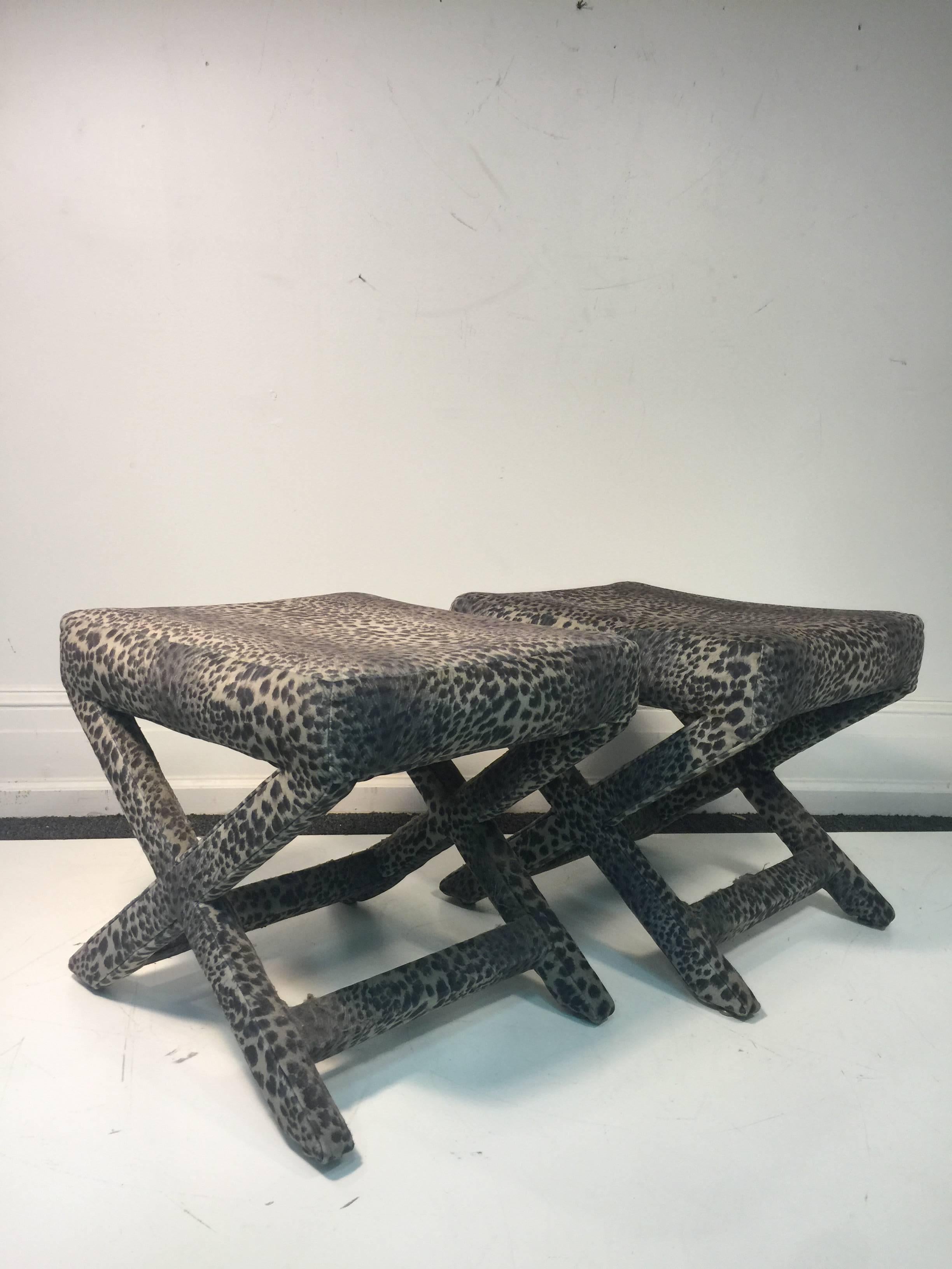 A lovely pair of X-base stools or benches upholstered in leopard print fabric, circa 1970. Good condition with age appropriate wear.