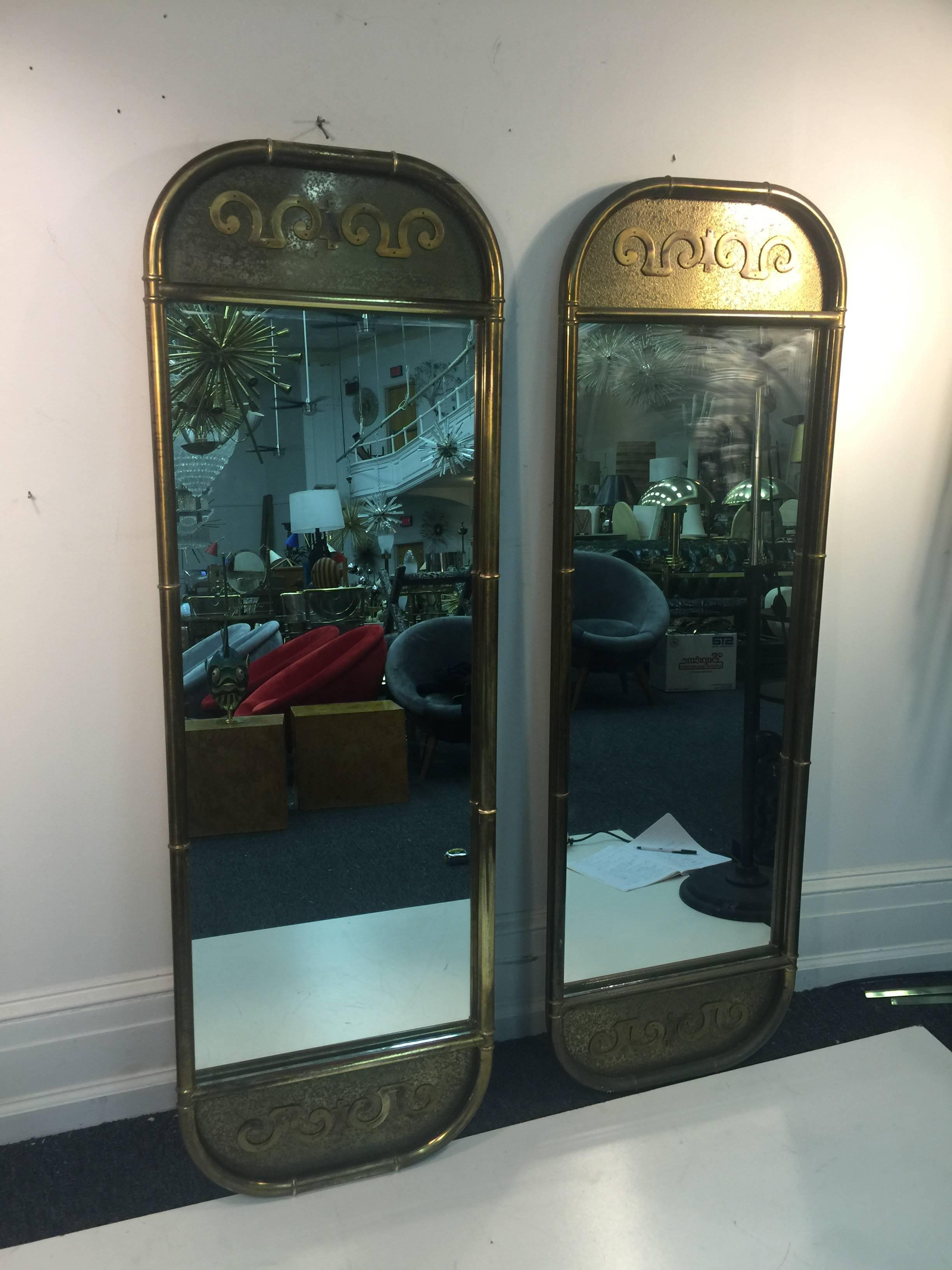 A magnificent pair of mastercraft full-length, brass, oblong wall mirrors with great detail, circa 1970. Wear consistent with age and use. Can be sold individually for $4950 each.