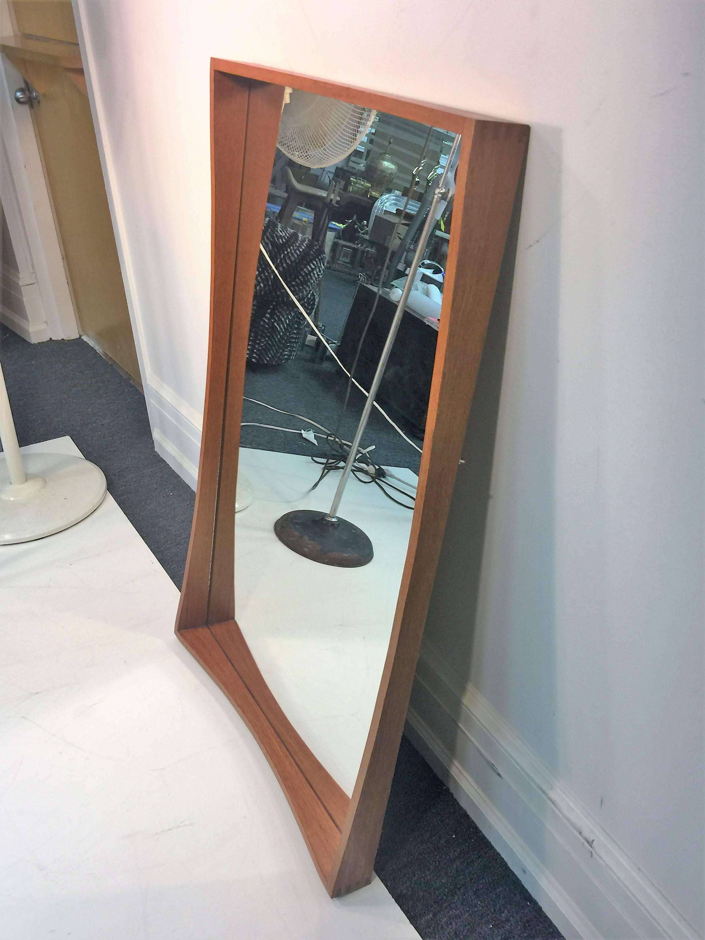 Great trapezoidal teak mirror designed and made in Denmark, circa 1960s. Wonderful sculptural and refined design with splined technique at the corners. A perfect mirror that would suit many interiors with Mid-Century Modern.