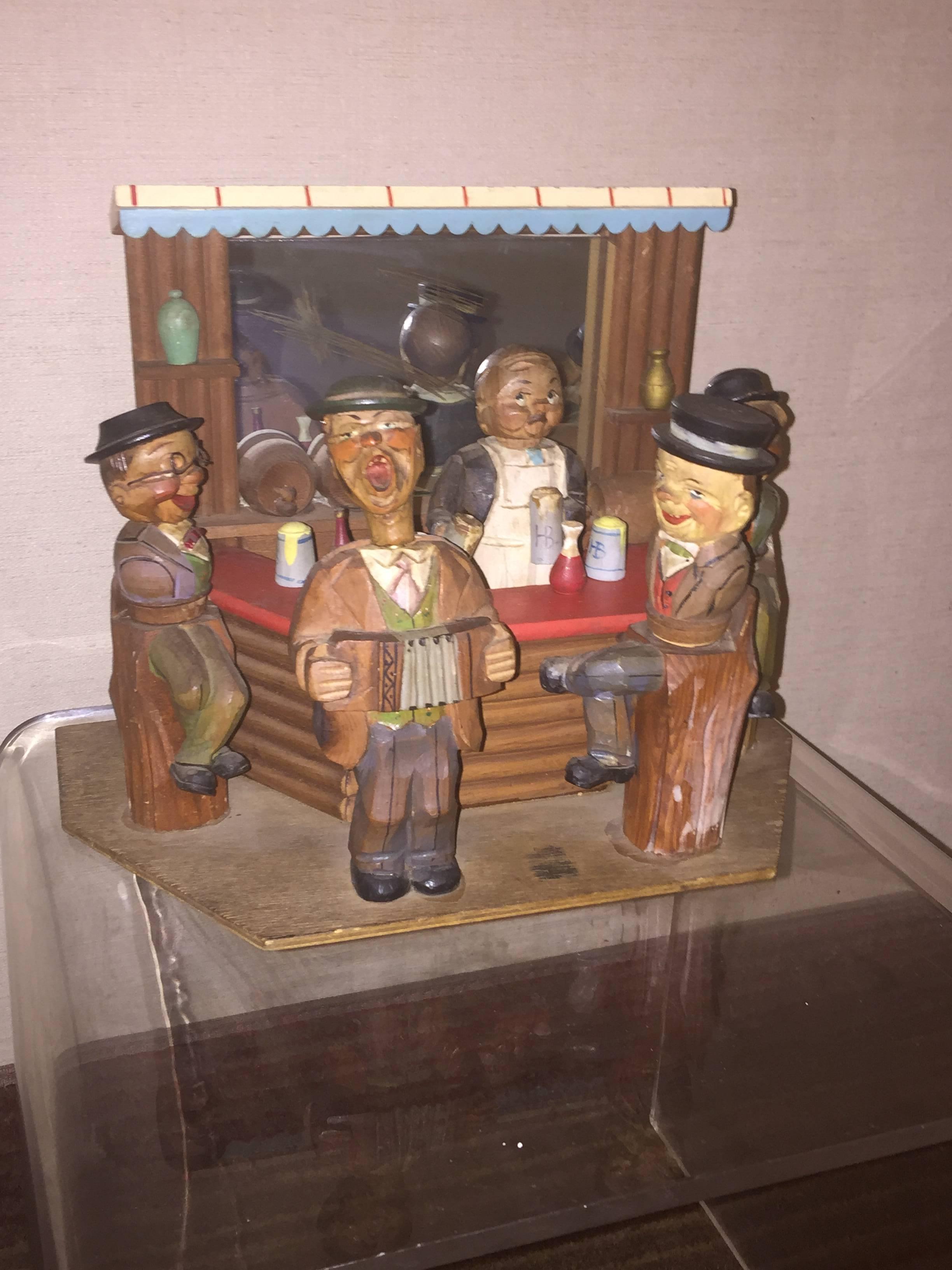 Five figure bar scene all hand-carved with interesting expressions and clothing.Designed and Hand Carved by Anri in the Italian Alps.
The Bartender is a corkscrew and the accordian player is a bottle opener. All the other seated figures are bottle