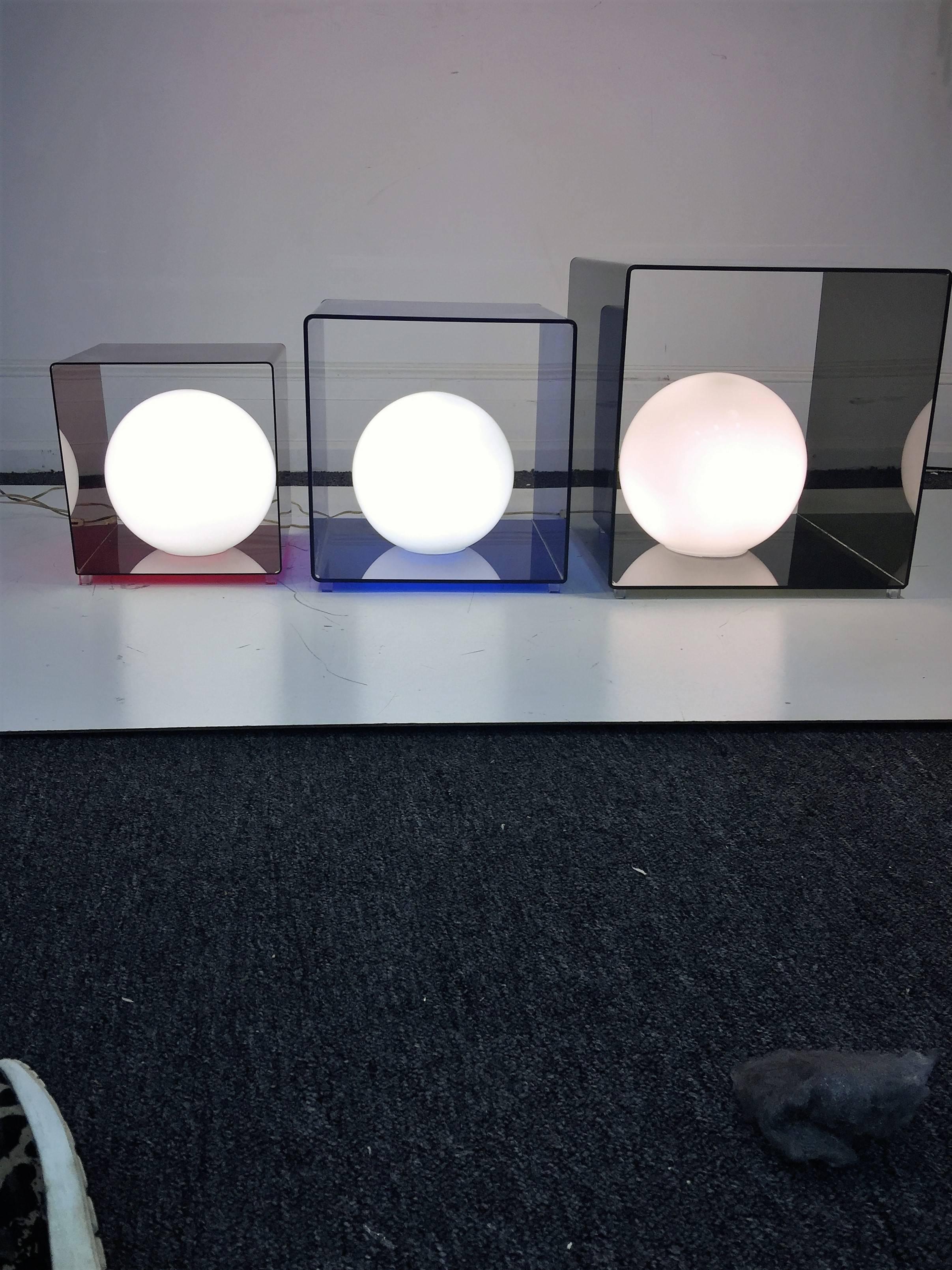 Cool trio of 1970s Lucite cube lamps with white glass ball shades. These can be used in many design configurations that give them great versatility for your interior. Large smoky grey cube - 18 1/2