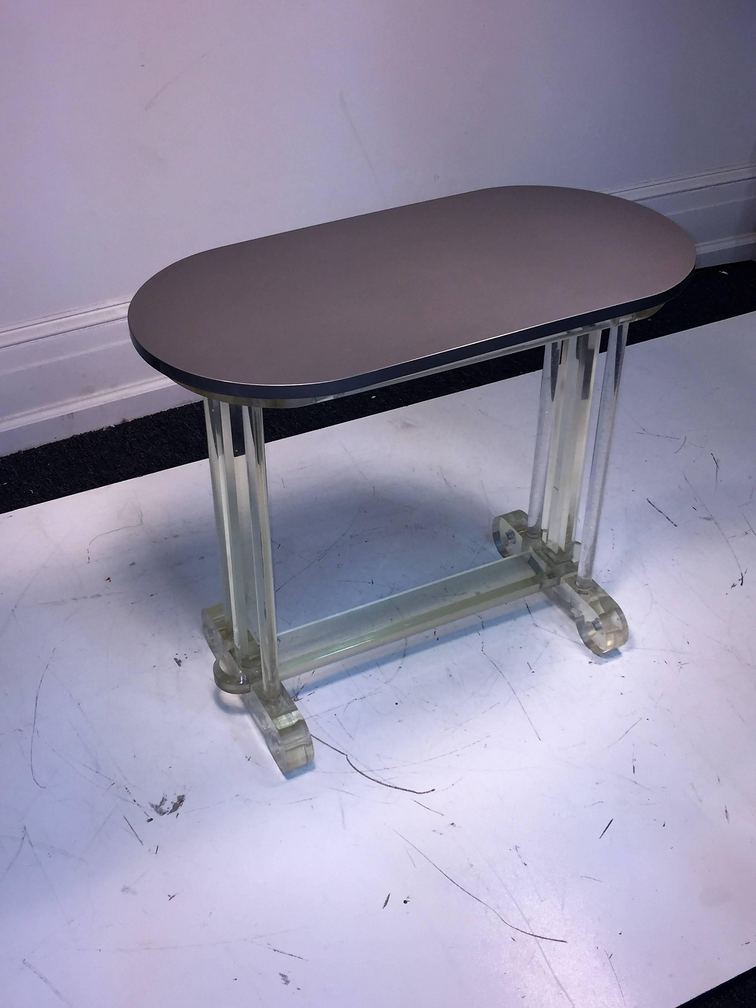 Nicely lacquered oblong wood table with substantial Lucite scroll and pole base. Formed with flat beveled stretcher in center of the base. Would be great as a side table with a great lamp upon it or as a cocktail table. Lucite base measures at 24