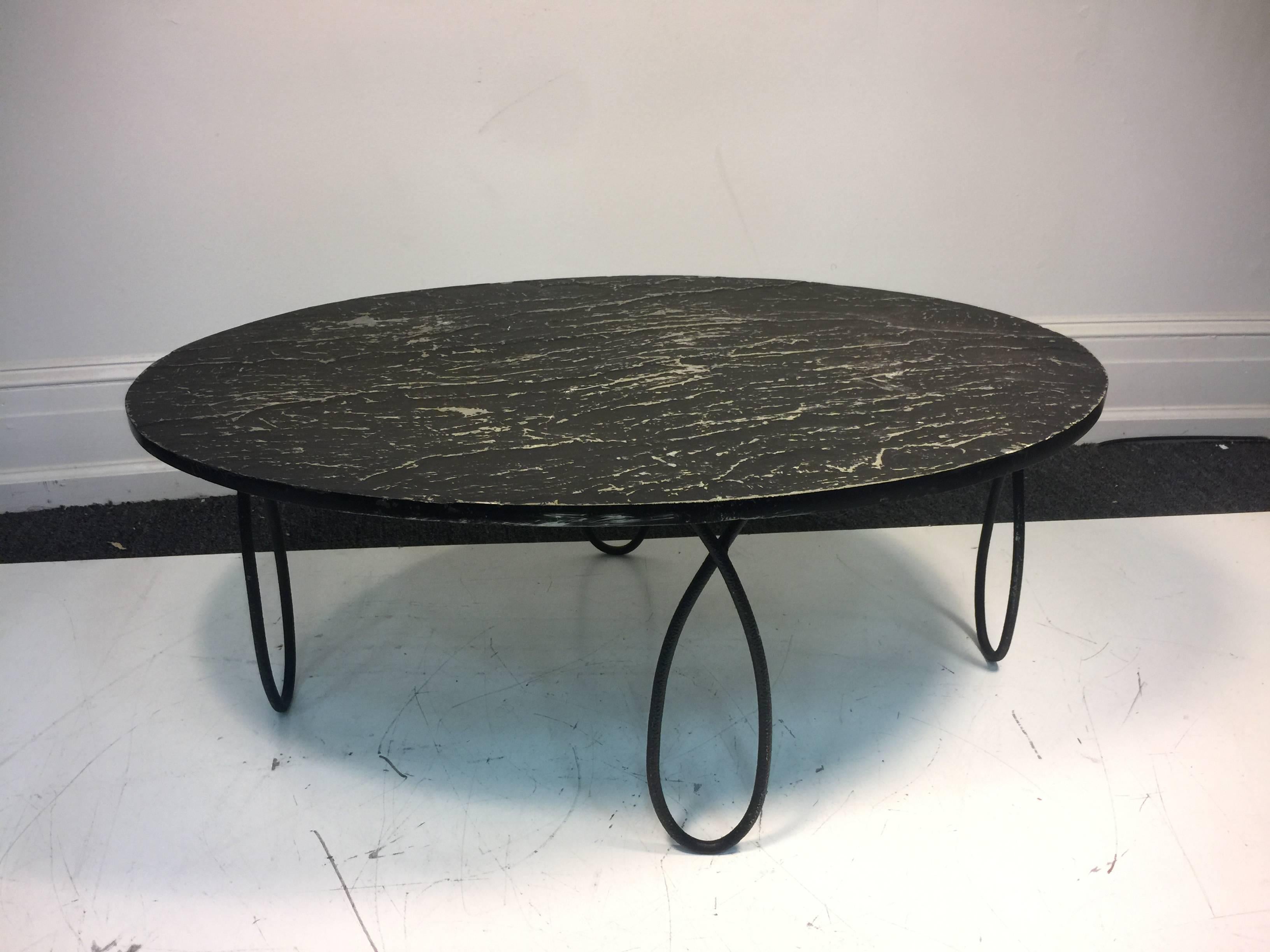 A stunning slate top coffee table with beautiful iron base in the manner of Jean Royère, circa 1970s. Good condition with age appropriate wear.