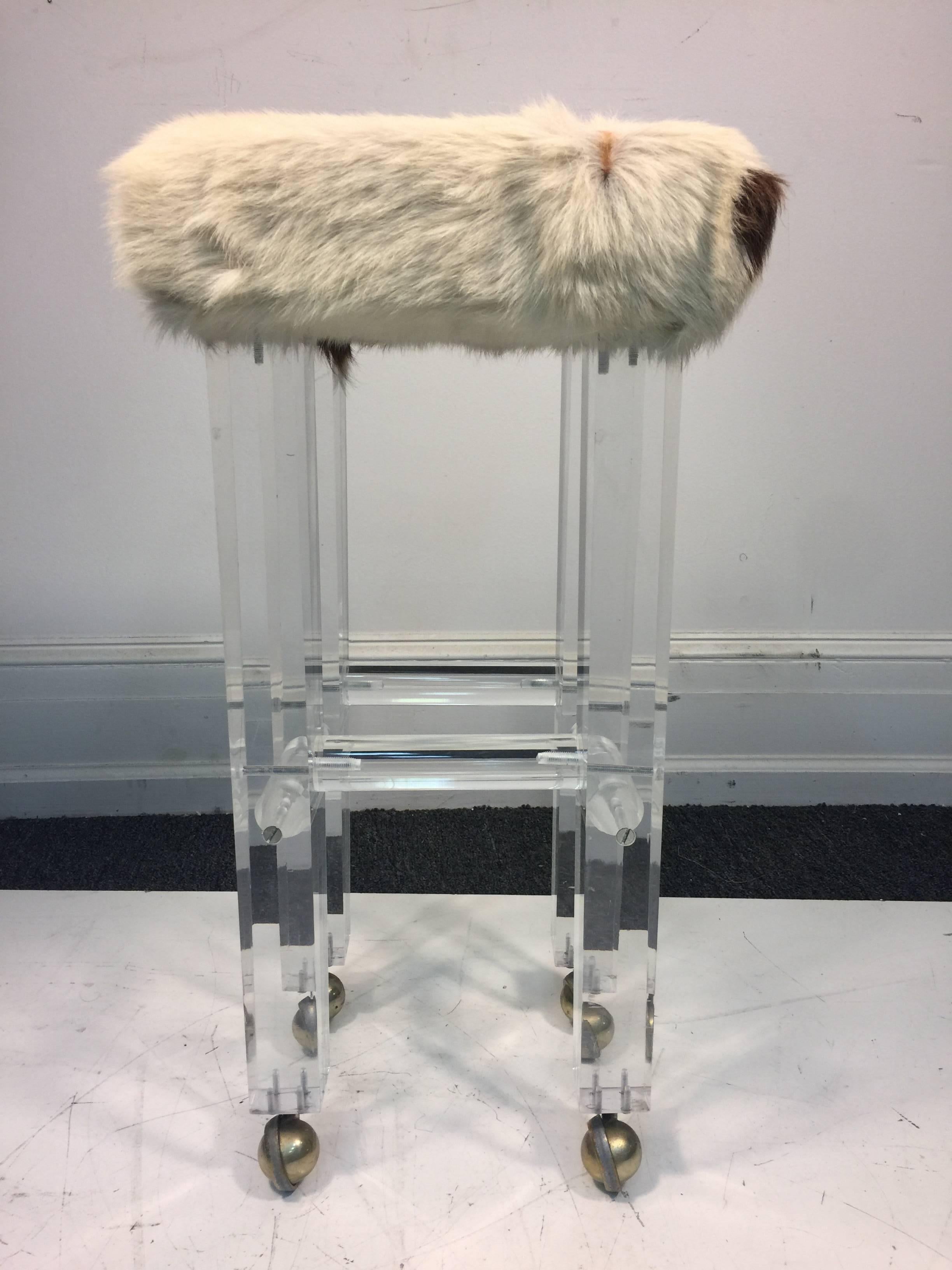 A fabulous Lucite modern stool or chair upholstered in cowhide and in the manner of Charles Hollis Jones, circa 1970.