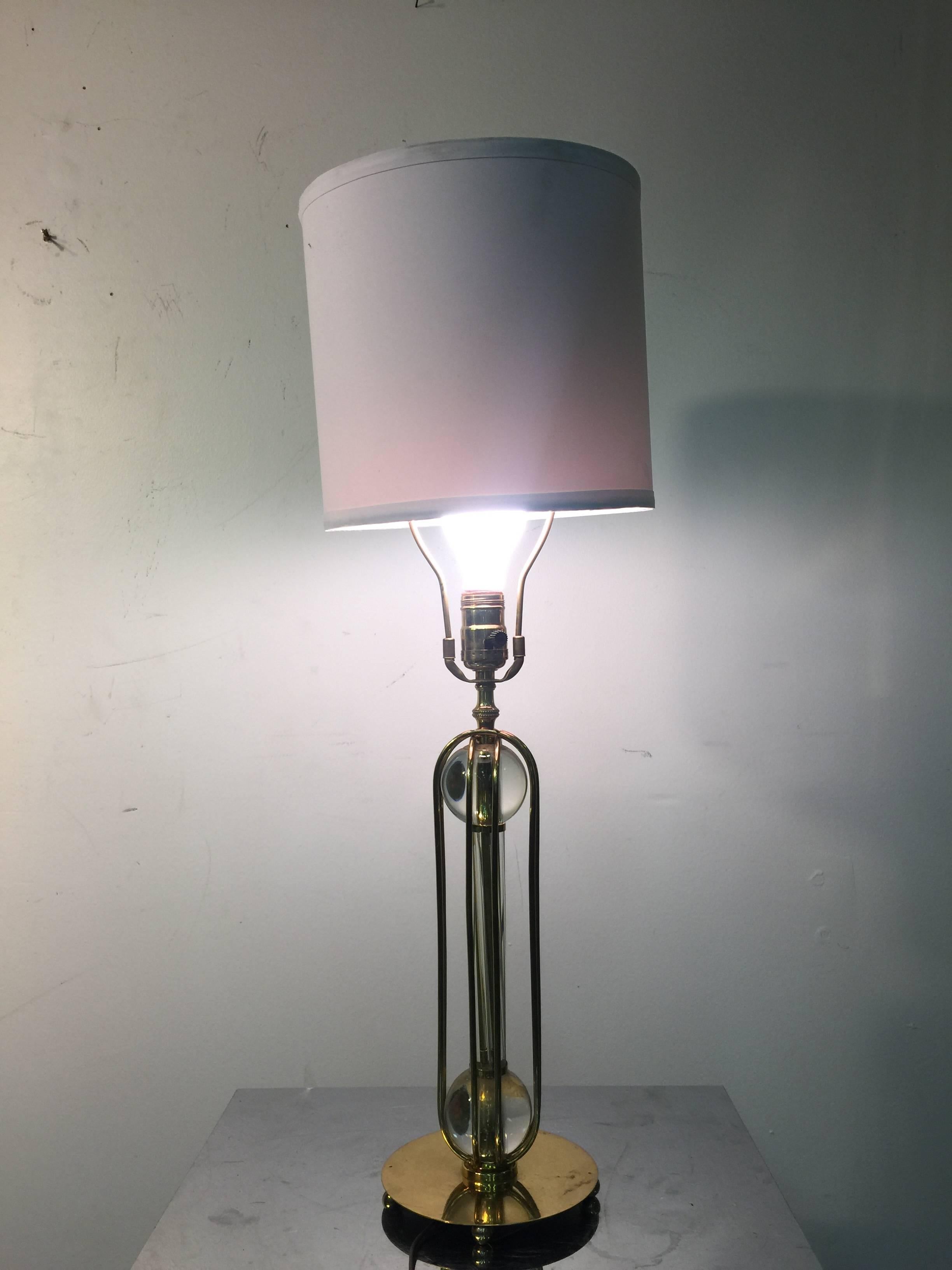 A beautiful brass table lamp with clear glass balls and cage design, circa 1970.