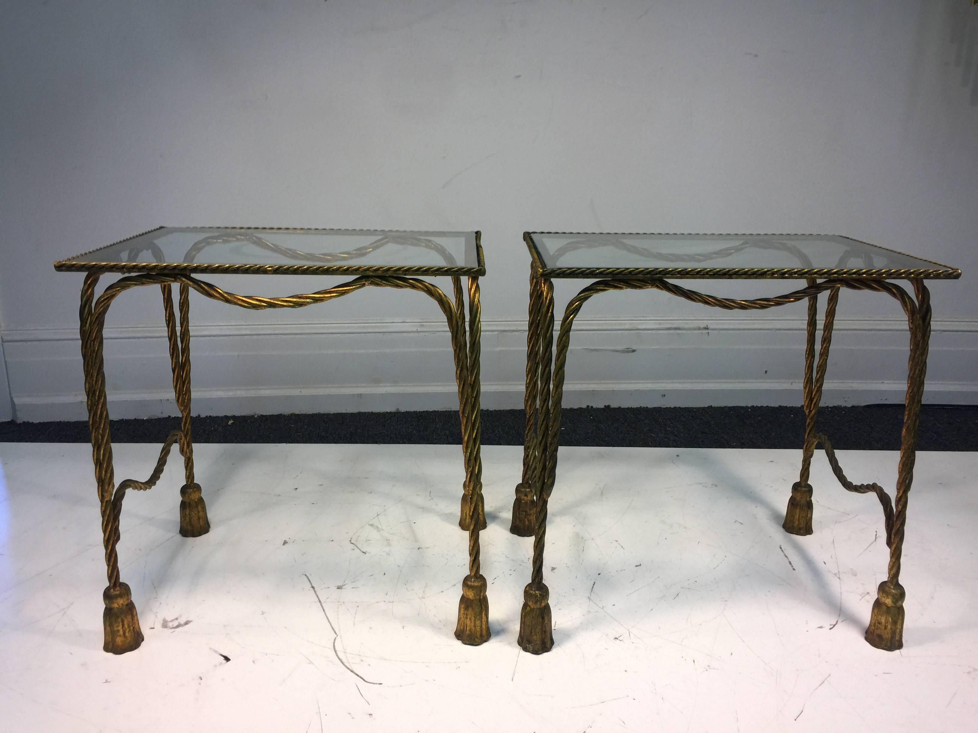 A stunning pair of Italian gilt metal side or accent tables with rope and tassel motif in the manner of Maison Jansen, circa 1970. Good vintage condition with age appropriate wear.