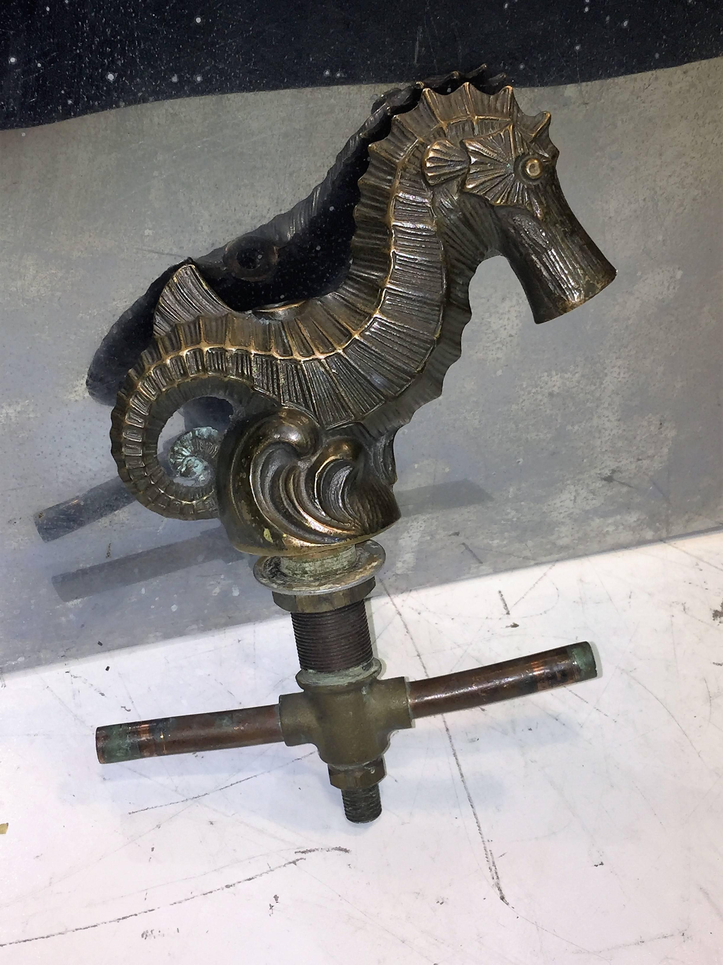 Substantial 1930s seahorse faucet and handles vanity sink set. The large seahorse is the main water faucet and the smaller pair is the handles. The hexagonal base is cast with a turtle, dolphin, crab, seahorse, scallop and starfish. Also has the