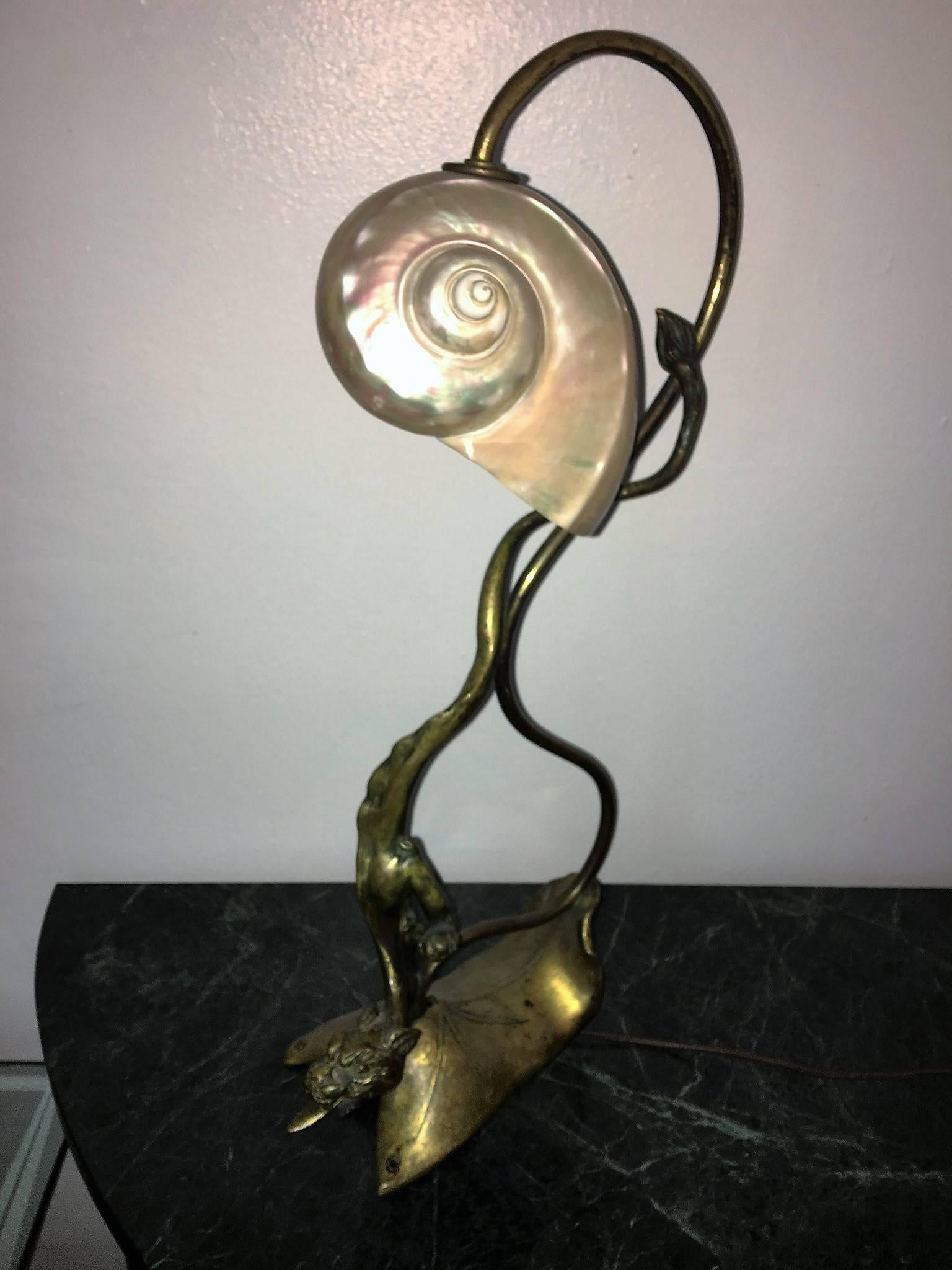 Ethereal sensuous design bronze descending dragonesque panther on stylized tree lamp. Done in the 1900s-1920s this period Art Nouveau lamp is a beautiful night light that can be an accent in your bedroom or desk. Fitted with a candelabra size light