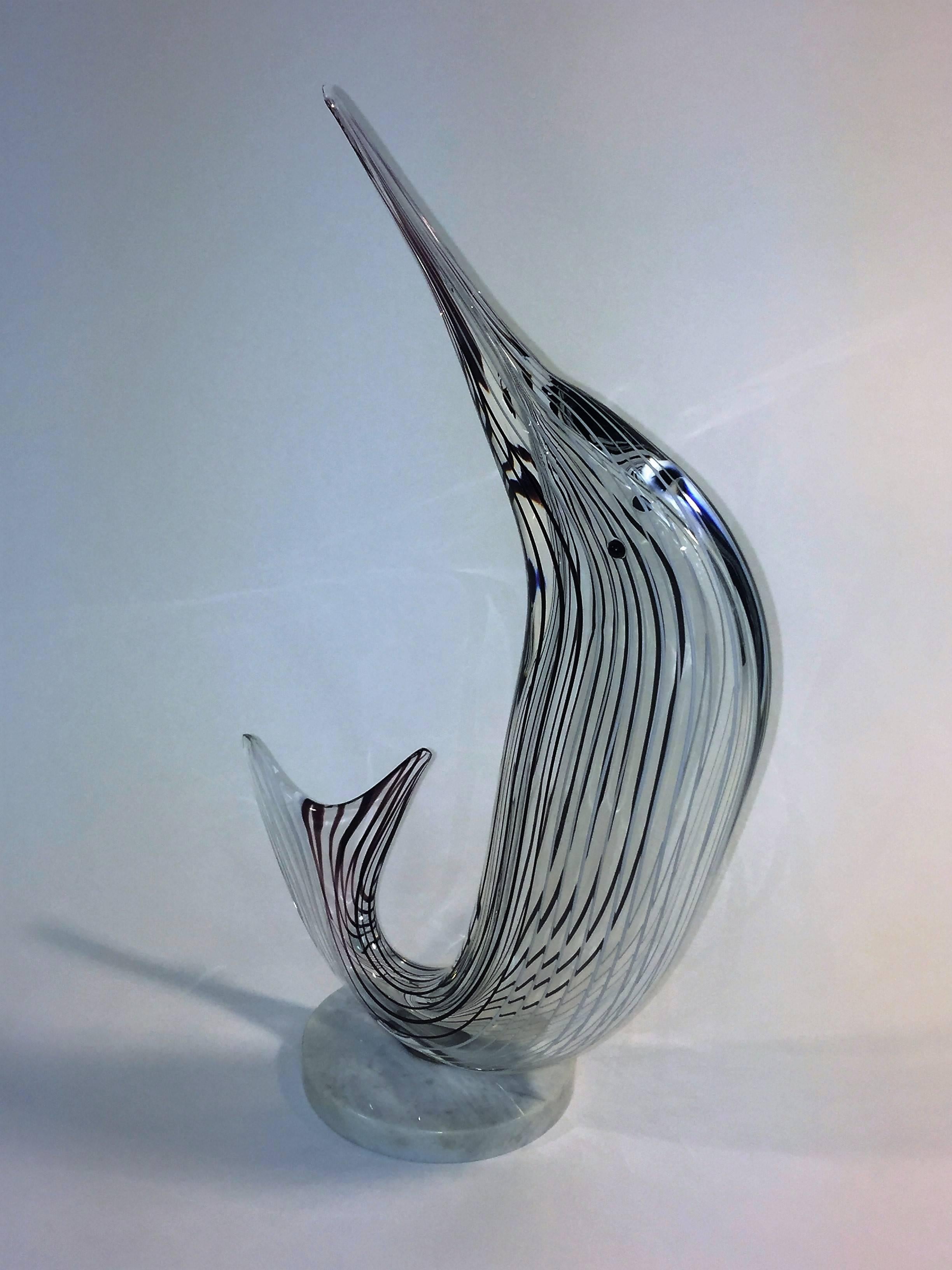 Modernist 1970s Italian handblown Murano glass sailfish sculpture mounted on round white marble base. Nicely blown in a swirl like form this charismatic sailfish has a black eye and lots of personality. The round white marble base is 6