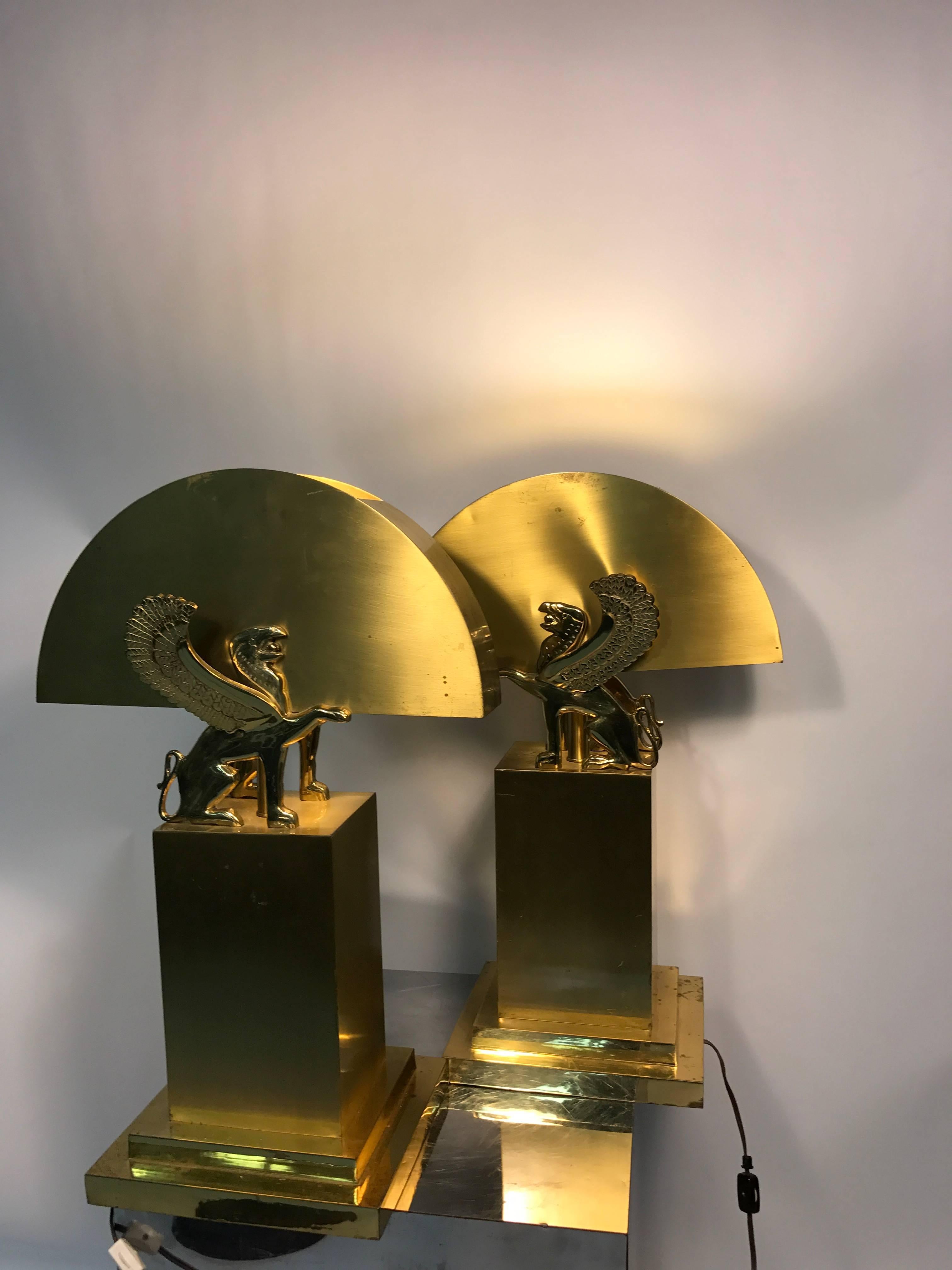 A wonderful pair of brass table lamps with winged lions in the manner of Gianni Versace, circa 1970. Good vintage condition with age appropriate wear.