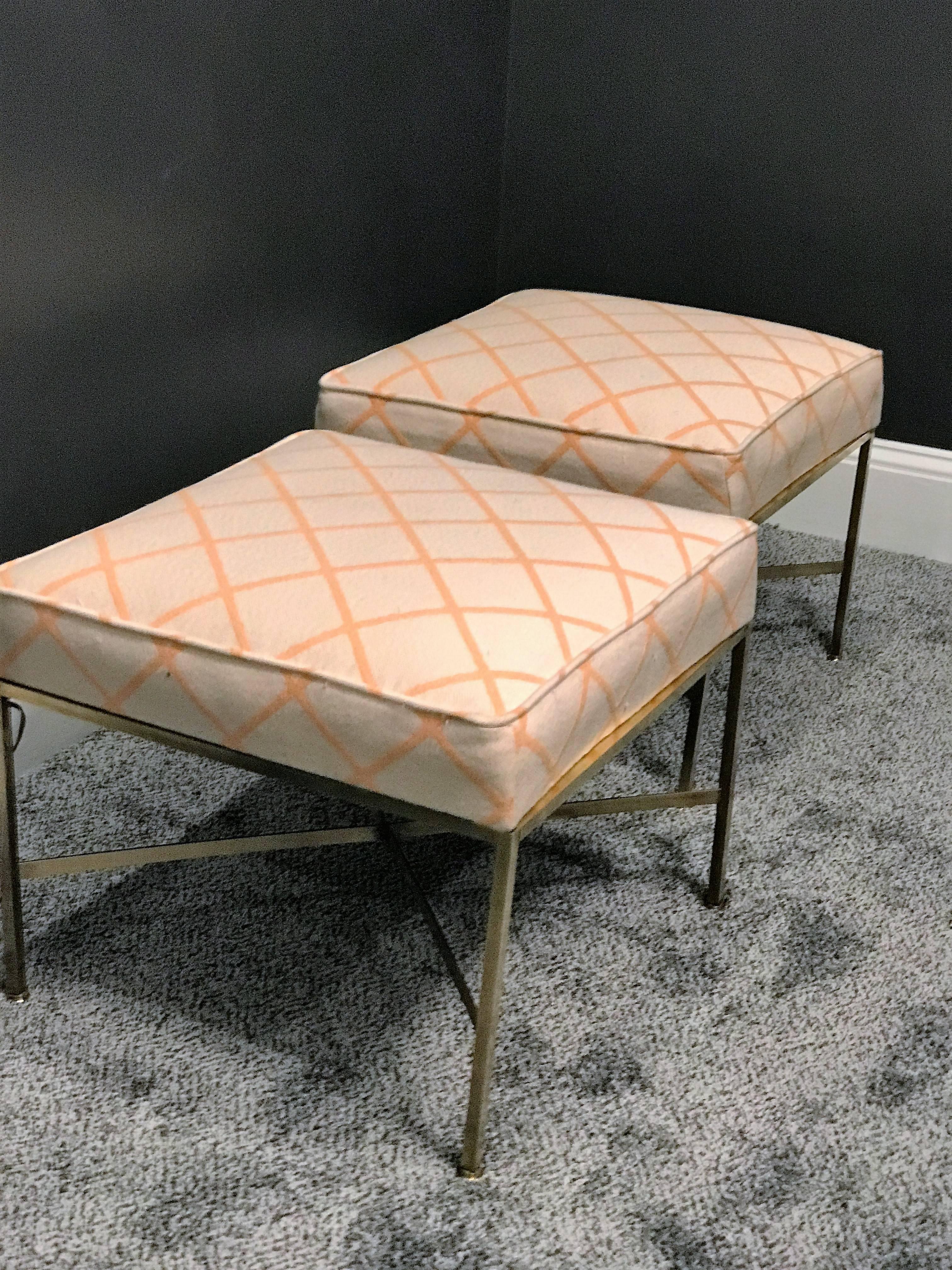 Polished brass tubular stools with the original Mid-Century fabric designed by Paul McCobb. Solid brass feet complete these versatile stools that could compliment many interiors.