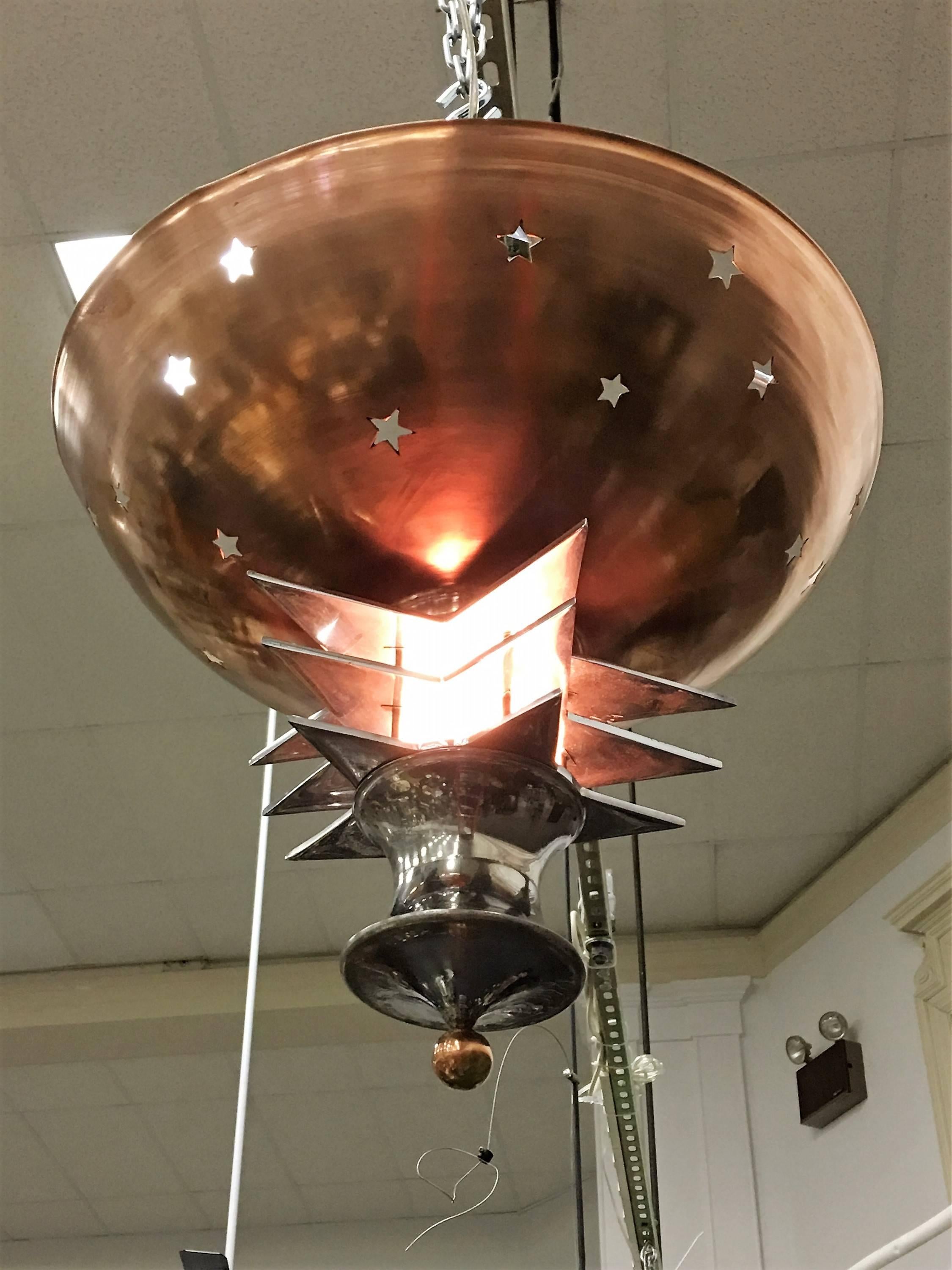 Fantastic multi dimensional copper and chrome finished art deco chandelier with a full four sided chrome star on top and a copper star studded cut-out bowl .Stacked chrome stars forms complete the base, milk glass shade covers the light fixture