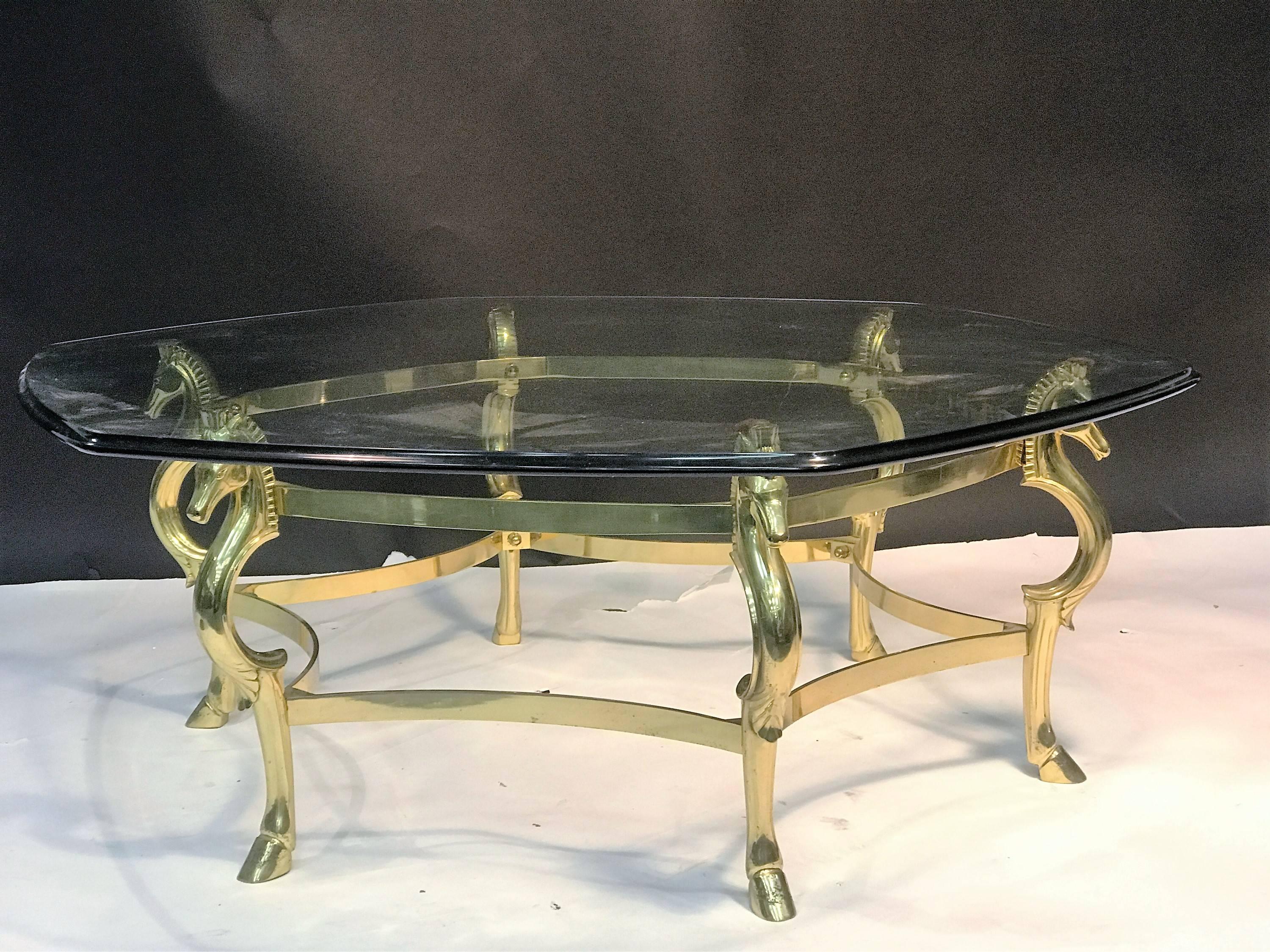 Stunning cast brass six sided seahorse and hooves coffee table with beautiful beveled glass top. Jewelry like polished brass that would be perfect in a high end eclectic modern interior. The beveled polished glass top is 3/4