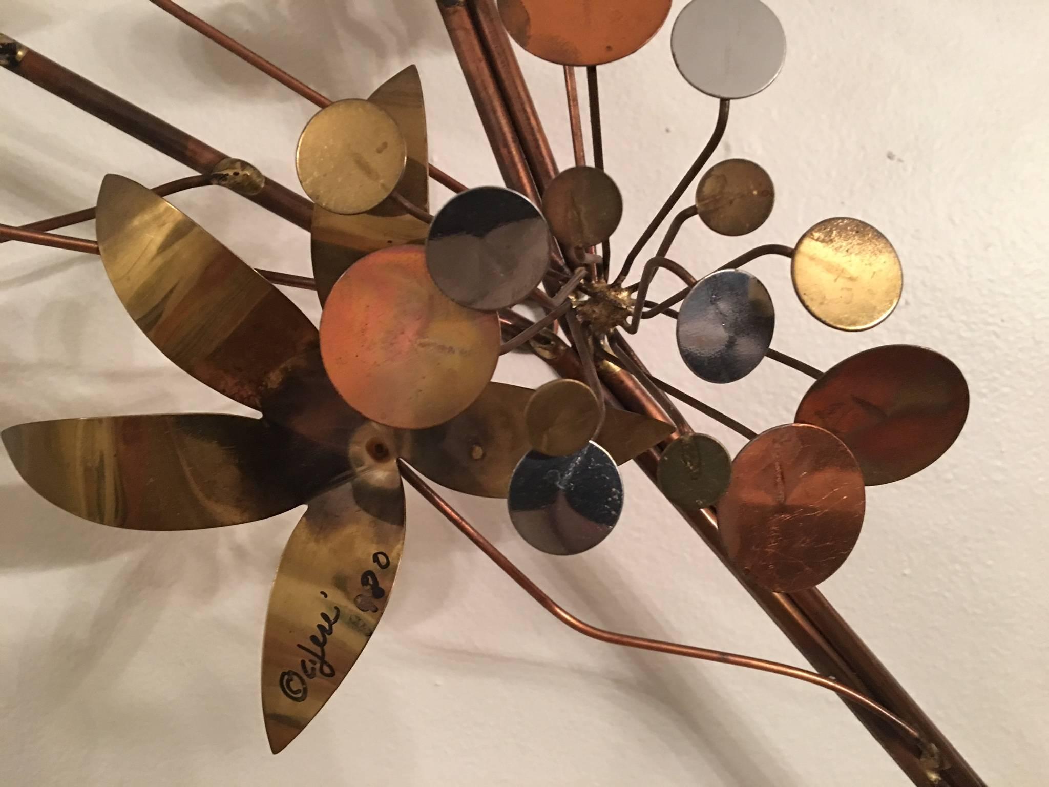 Great mixed metal Curtis Jere flower spray with hues of copper, chrome and burnished brass. Unusual design with clusters of raindrop discs mixed into the floral spray. Signed C. Jere, 1980.This sculpture can be hung horizontally or vertically