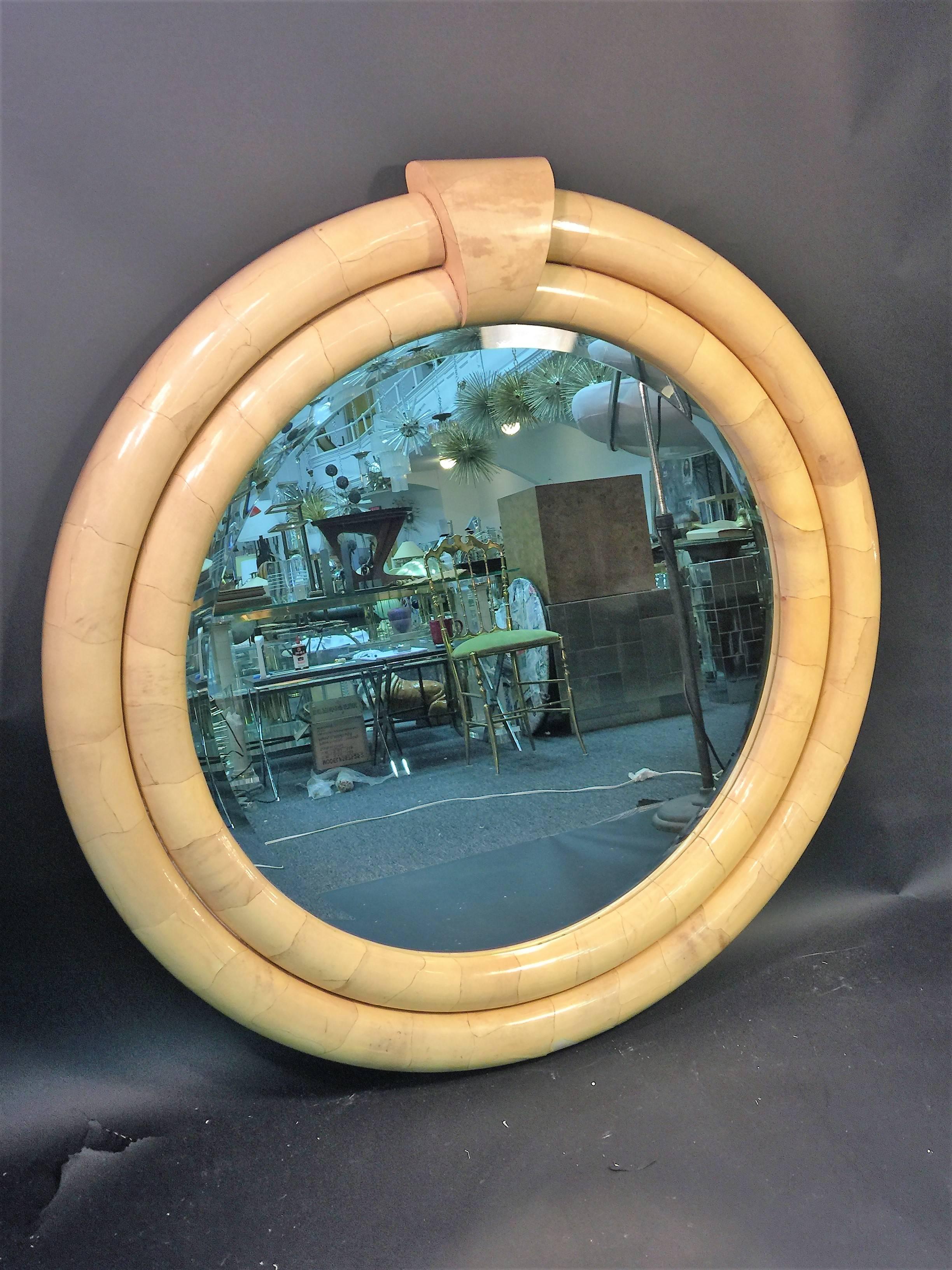 Beautiful round double levelled goatskin mirror beautiful deep yellow hued mirror with dramatic bevelled round mirror. Fantastic form and design that would be incredible in a high end modern interior. The depth of the mirror is 3 1/2