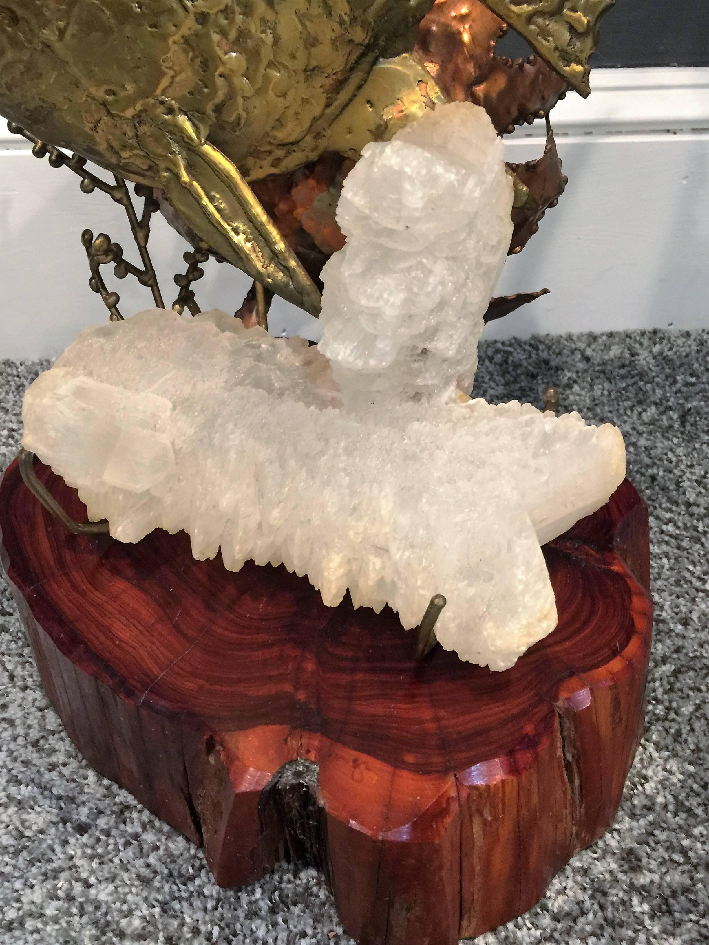 Amazing hand-sculpted brass fish amongst a sculpted copper sea plant and a cast bronze coral. Great piece of quartz crystal is held by a four prong gem style bronze setting. All this action upon a natural tree trunk base. Created in the 1970s by