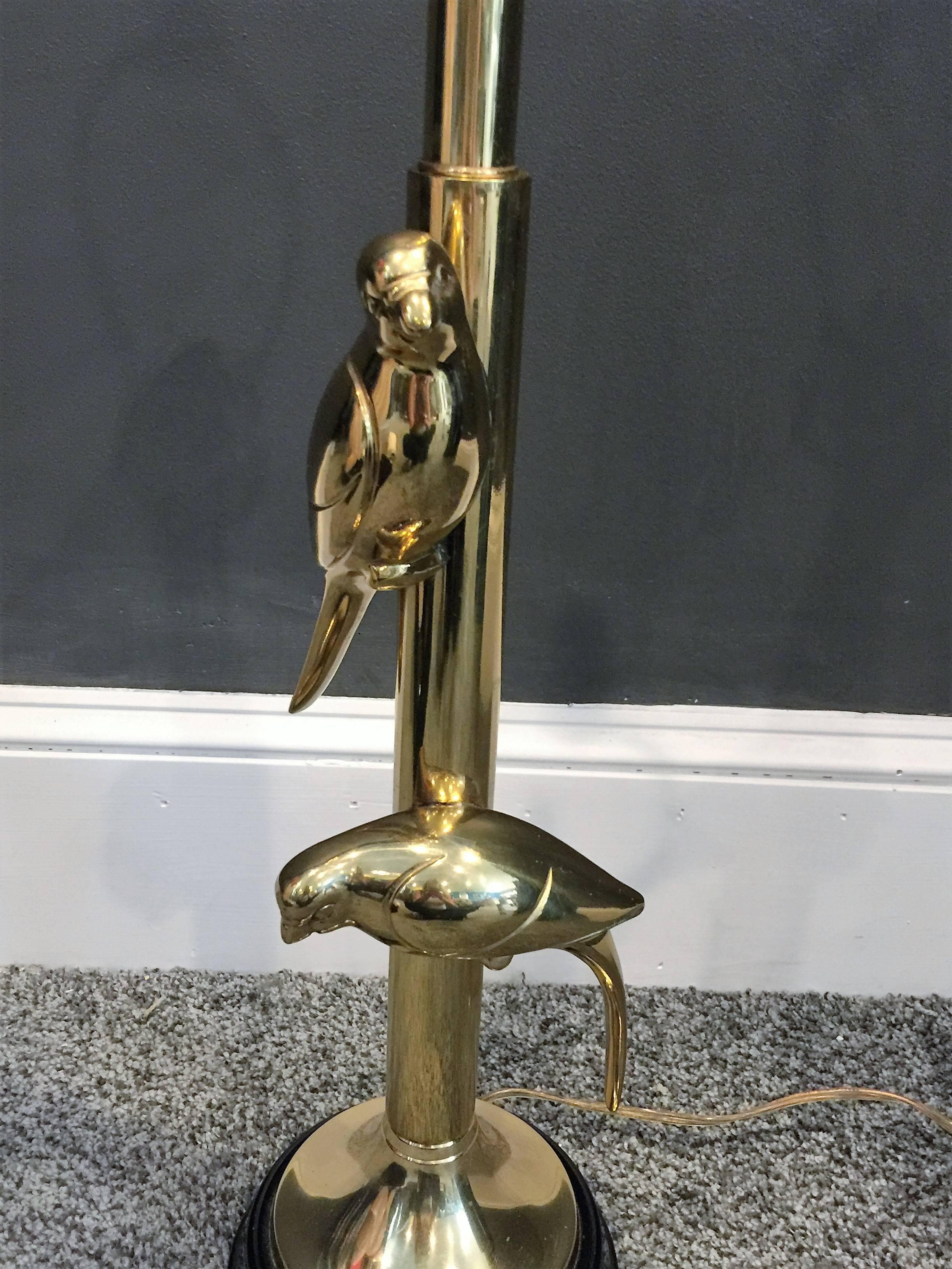 Beautifully made polished brass pair of parrots that are three dimensional on the lamps stem, original decorative ball finial completes this lamp with a glossy black enamel metal base. The base is 6 1/4