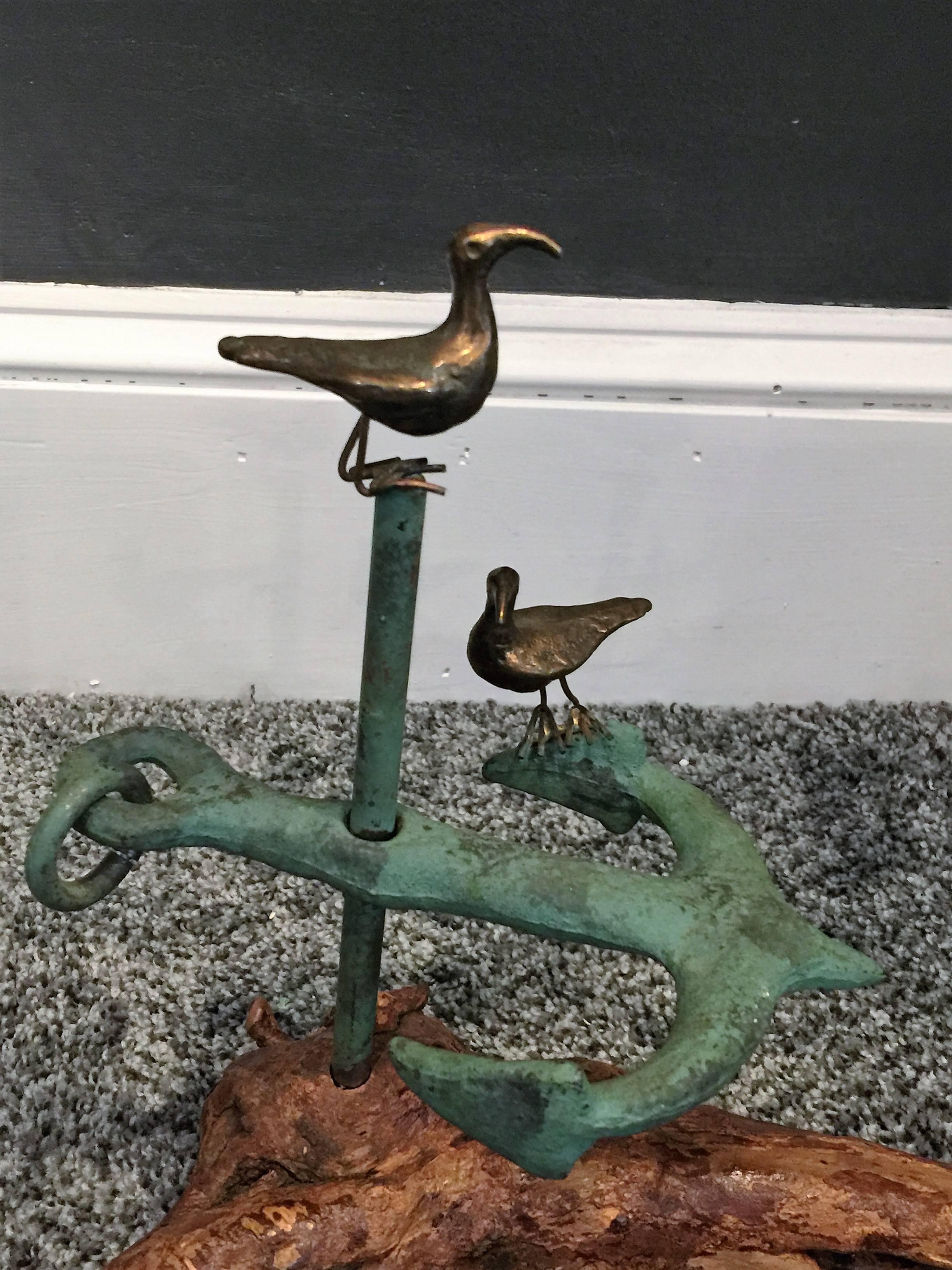 Nice pair of bronze seagulls resting on a Verdigris bronze anchor with moveable ring on driftwood base. Signed and dated 1971. Nice for your summertime dining table feast.