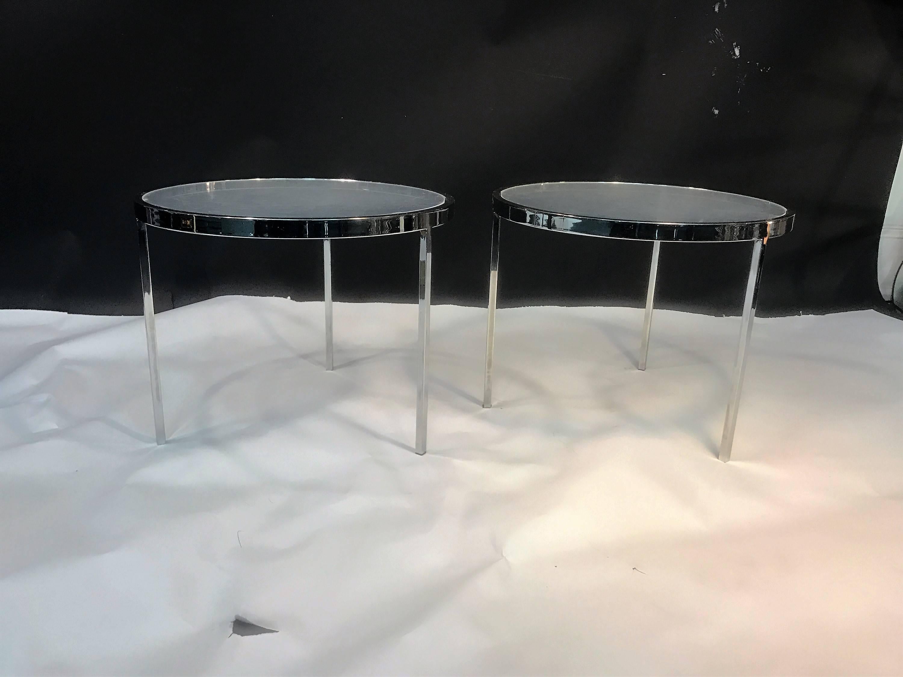 Pair of sleek modernist three legged tables with round glass top designed by Milo Baughman. Great form in chromed metal square and flat tubing and banding.