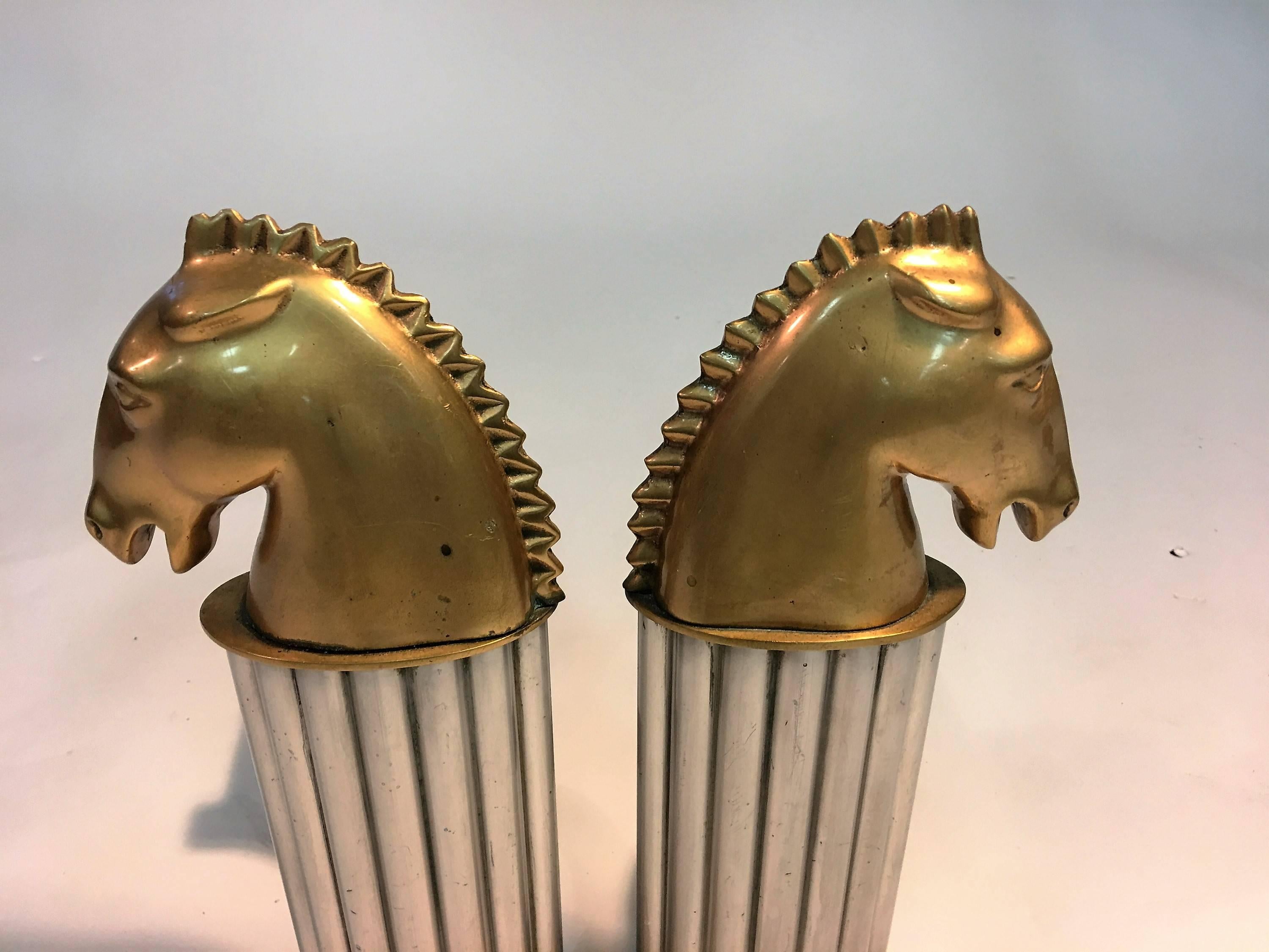 Jewelry grade bronze sculpted horse head on a fluted aluminum column and mounted on bronze base andirons. Designed in the 1930s these are fantastic for an art deco fireplace.