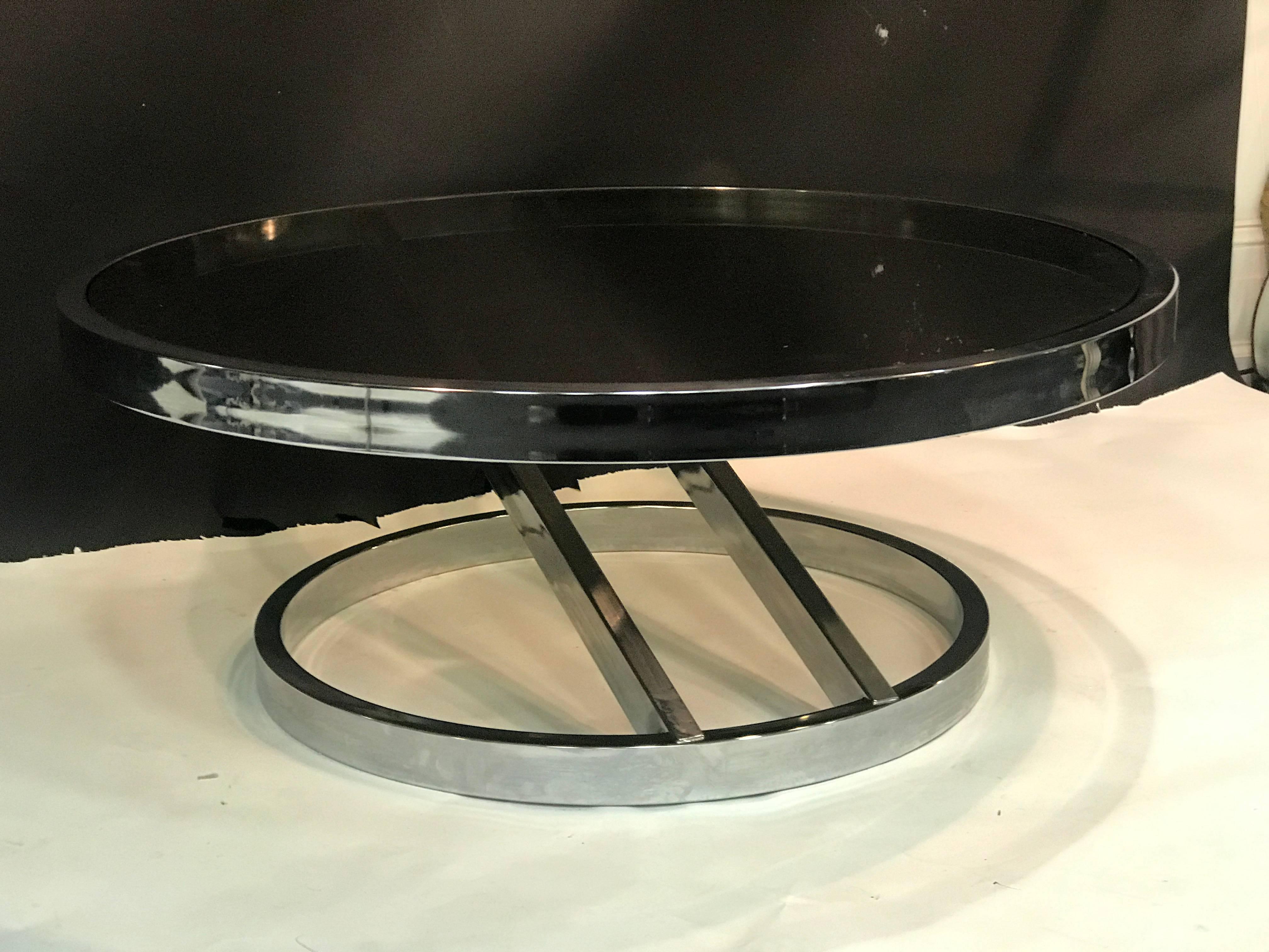 A striking chrome coffee or centre table with smoke glass top by Milo Baughman, circa 1970. Good vintage condition with age appropriate wear.