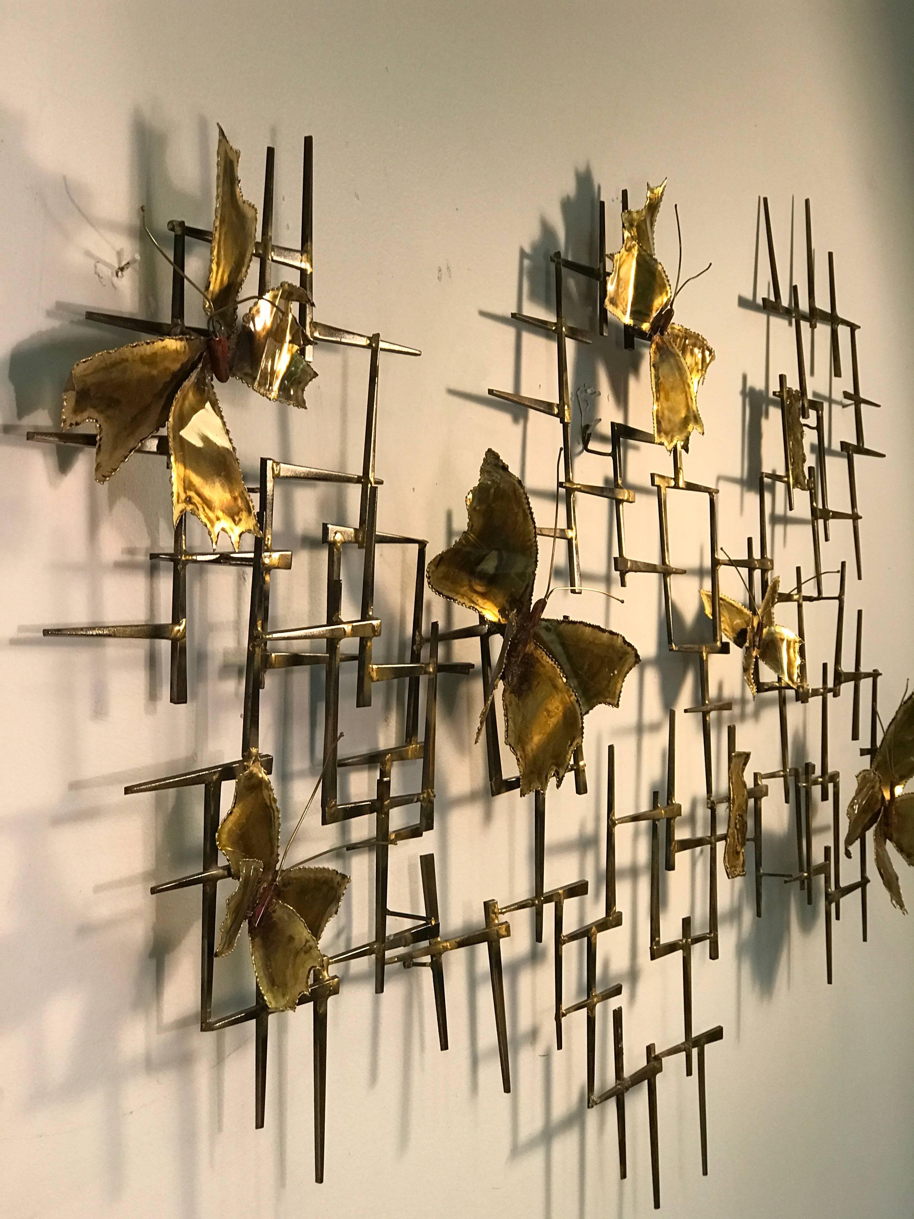 A monumental mixed-metal and brass nail wall sculpture with beautiful butterfly accents by Curtis Jere, circa 1970. Good vintage condition.