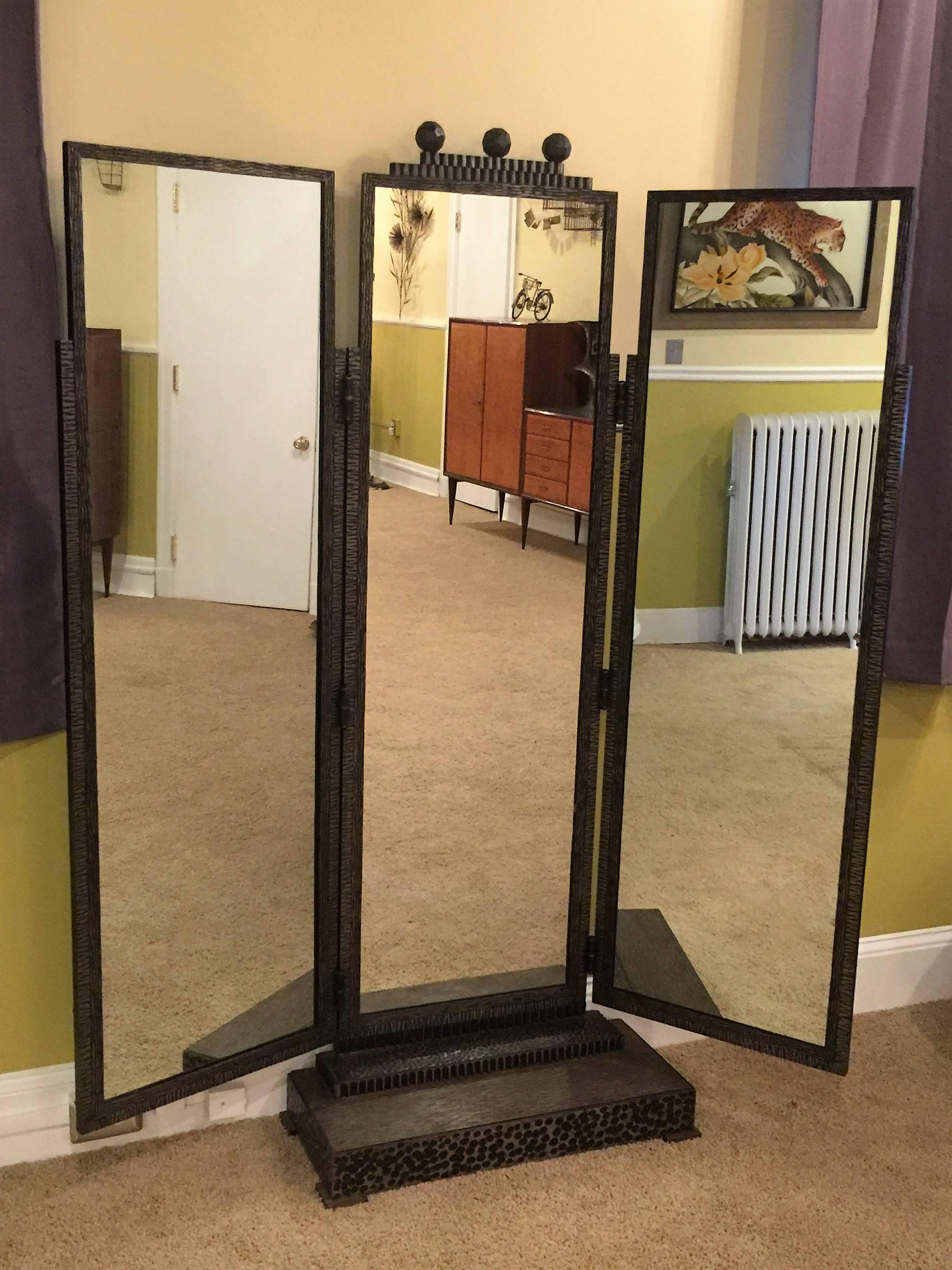 Substantial and heavy wrought iron art deco dressing mirror. Great hammered and textured three paneled mirror that has adjustable hinges so you can move the two side mirrors to your liking. Great stepped base with four square feet and three faceted