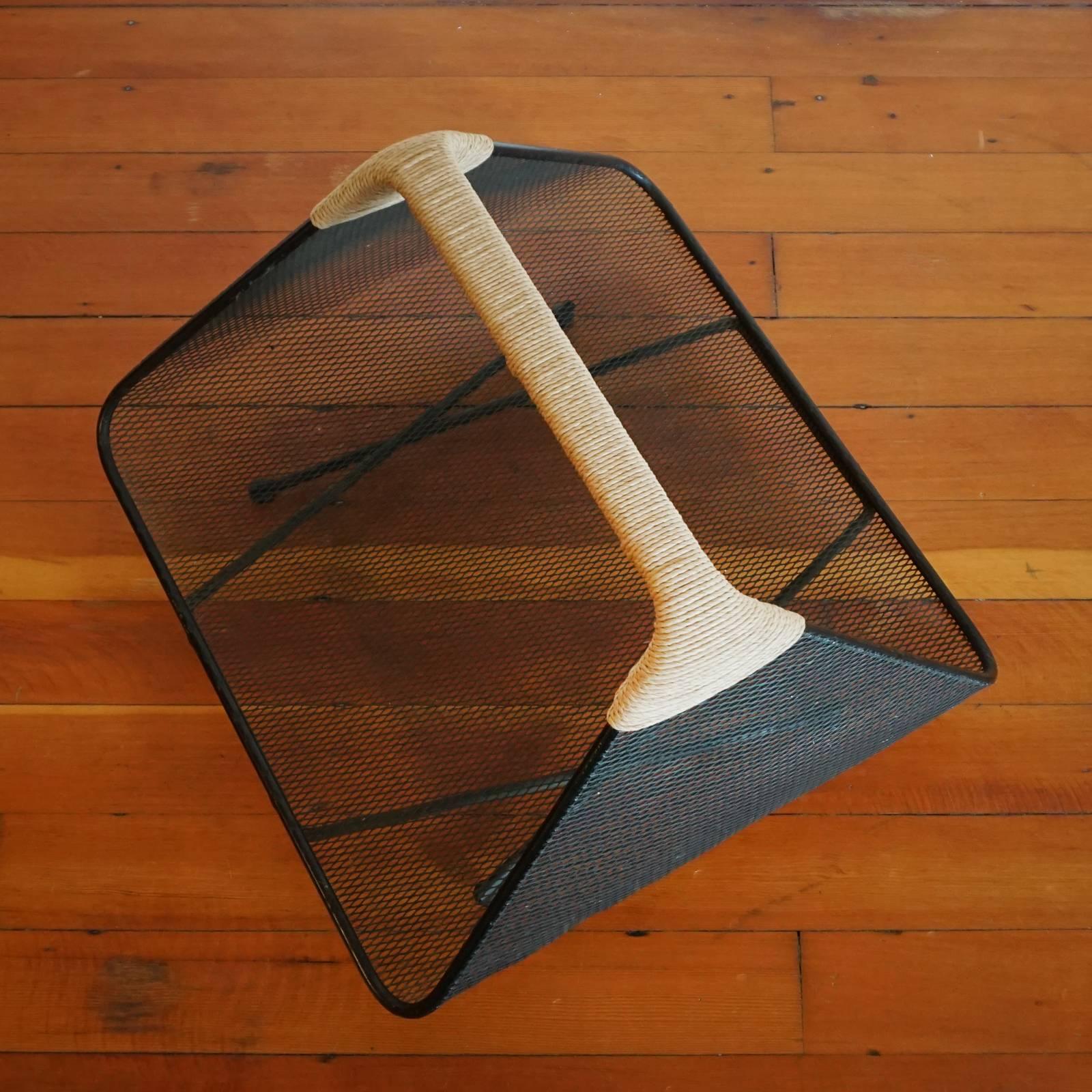 Magazine or log holder by Tony Paul for Woodlin-Hall. Iron frame, mesh body and rush-wrapped handle, 1950s.