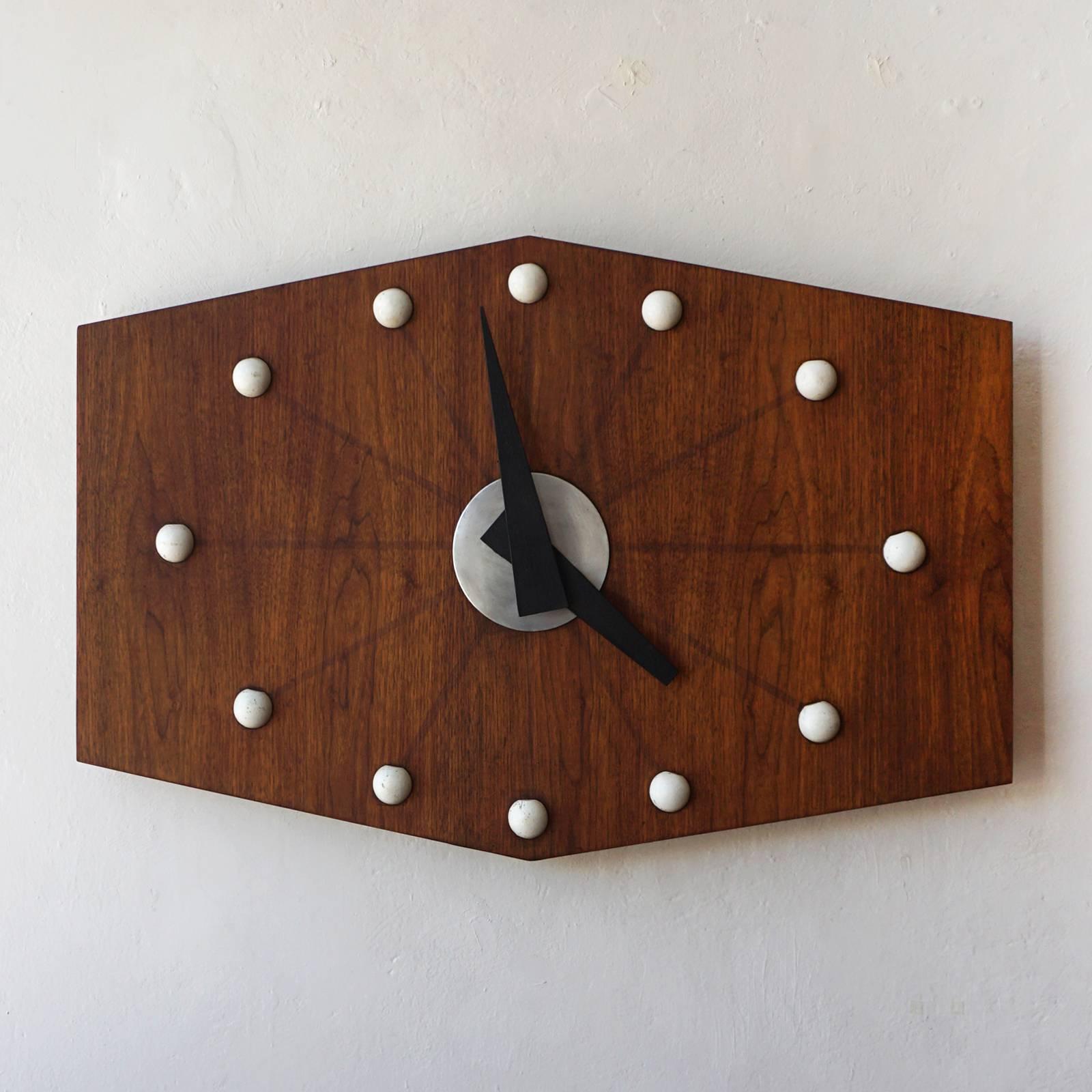 Large-scale wall clock from the 1950s. Painted wood balls, metal hands and a walnut body. Keeps perfect time.