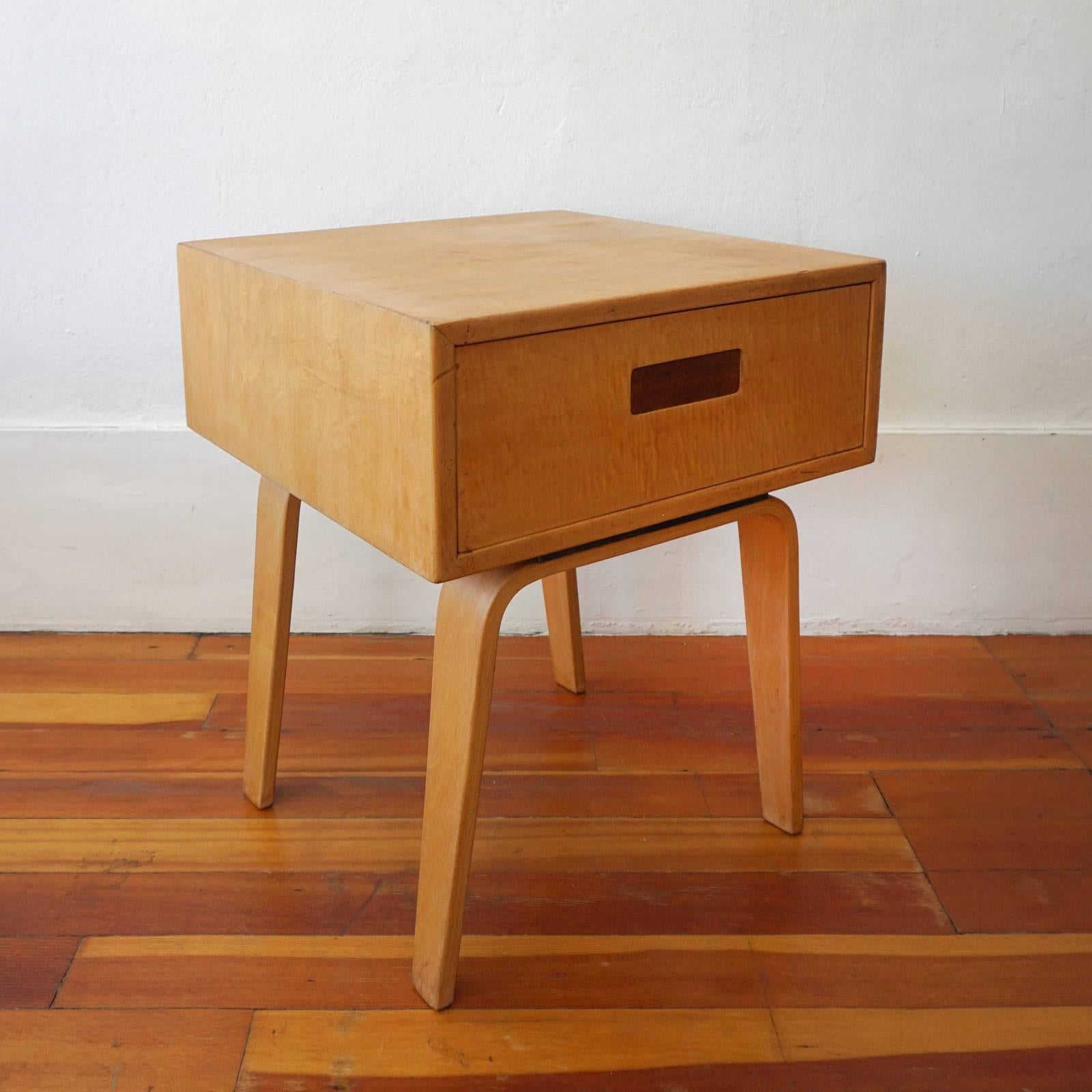 1950s birch end table or nightstand by Clifford Pascoe for his company, Pascoe. The single drawer unit has a spring loaded recessed pull. 

Pascoe had a showroom in New York City and a manufacturing facility in Wisconsin. They produced their own