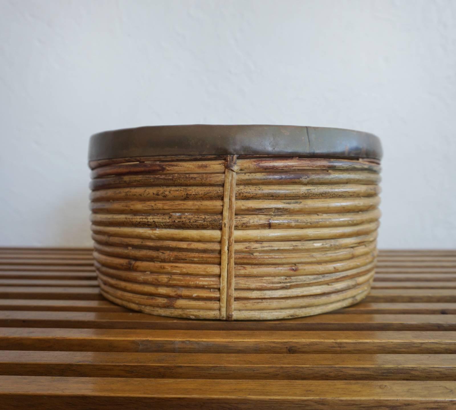 Rattan bowl with copper rim. Designed by John Risley for Raymor. Produced in the early 1950s.

Starting in 1951, John Risley worked with local craftspeople in the Philippines to develop products for the US market. Companies like Raymor imported