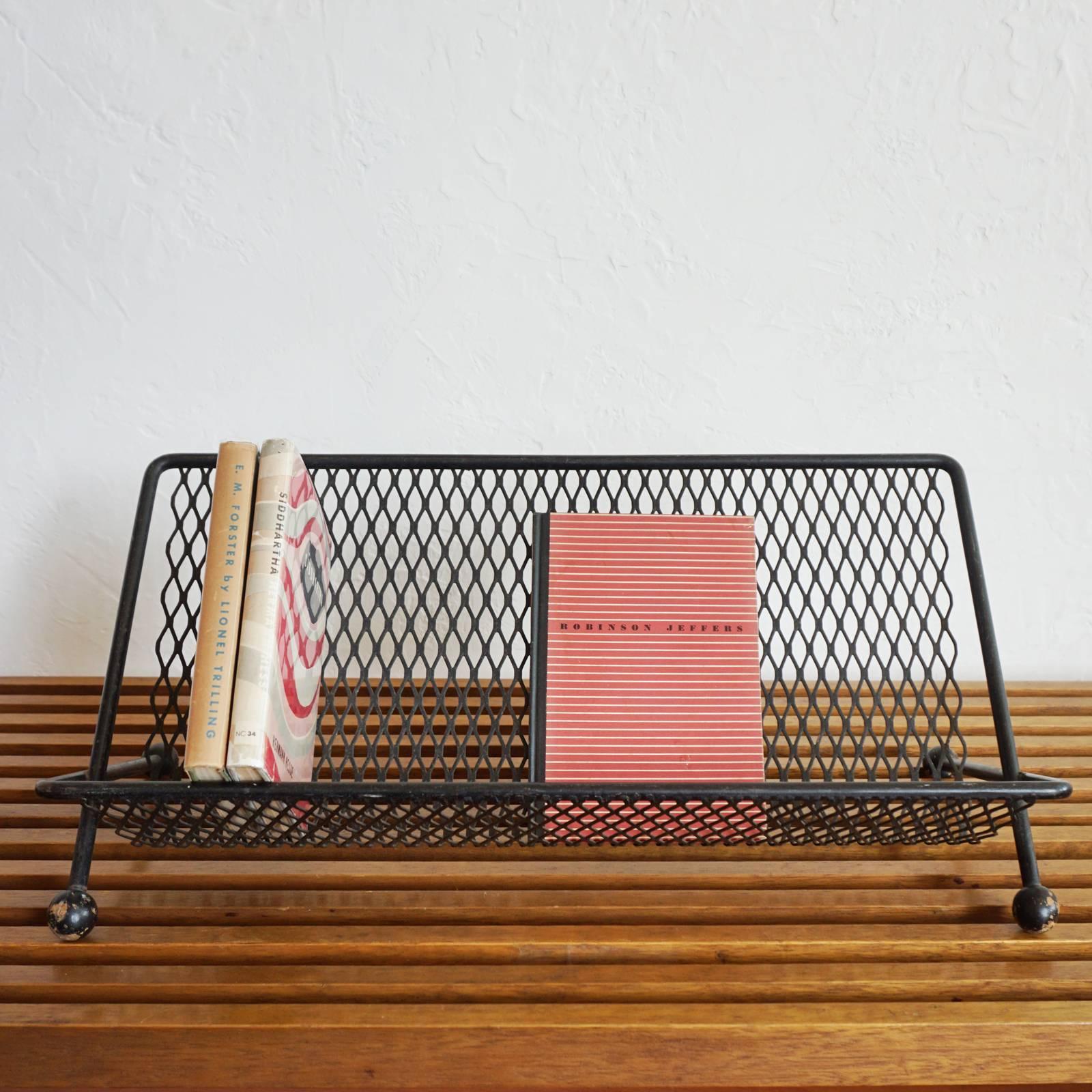 1950s expanded metal book stand with wood ball feet.