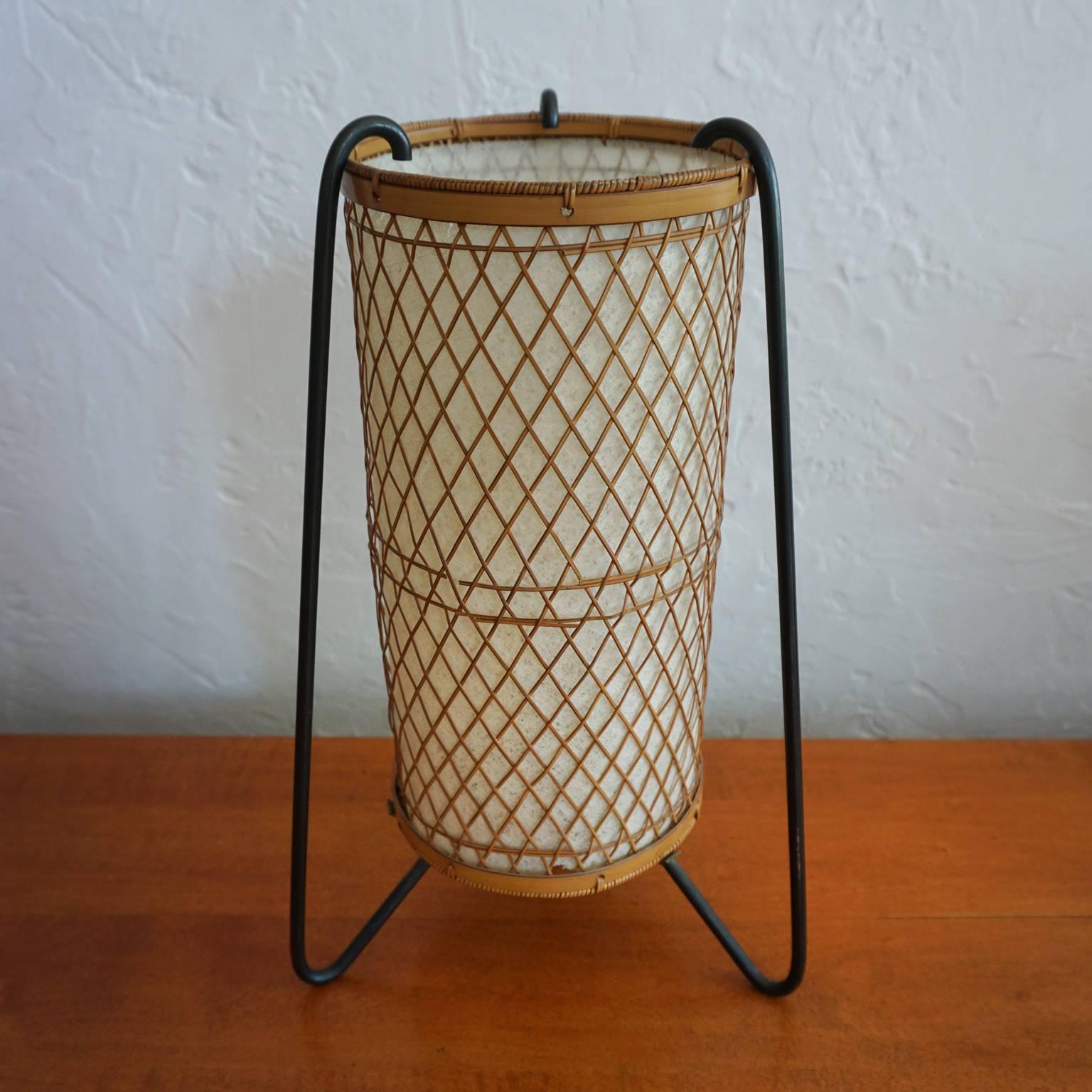A delicately designed iron and cane lamp from Japan. The cane work is incredible and undamaged.