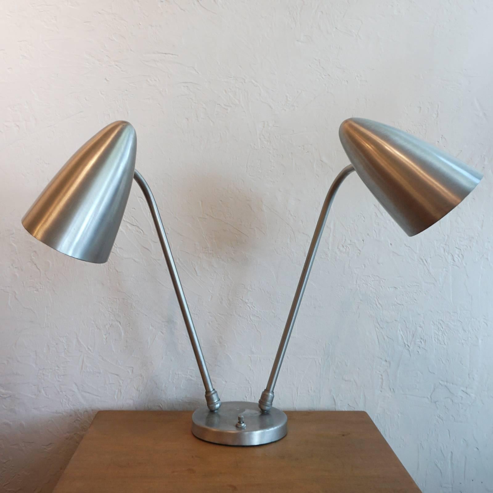 Fully adjustable dual cone spun aluminum lamp by General Lighting company. 

In 1949, the 