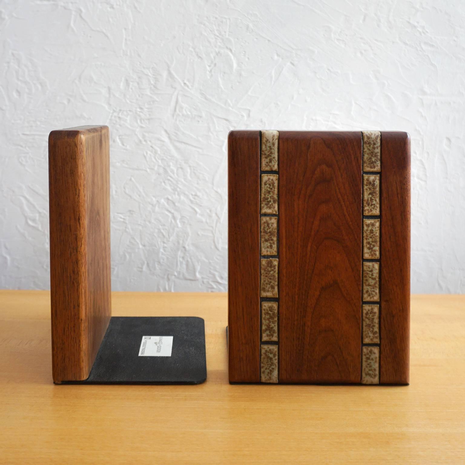 Bookends by Jane and Gordon Martz for their company, Marshall Studios. Oiled walnut with glazed ceramic elements. Retains an original label.