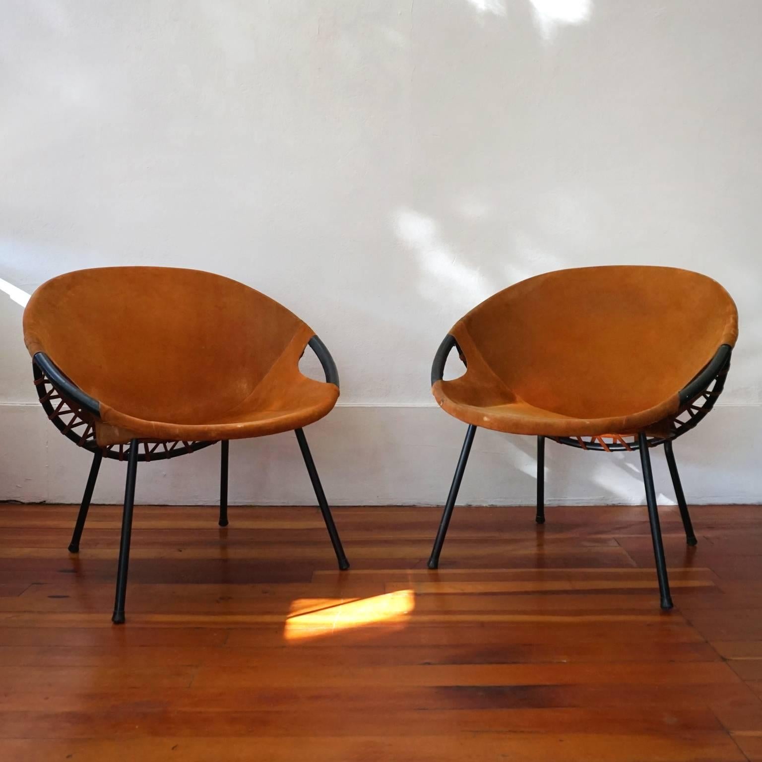 A pair of suede leather and metal frame chairs from the 1960s.