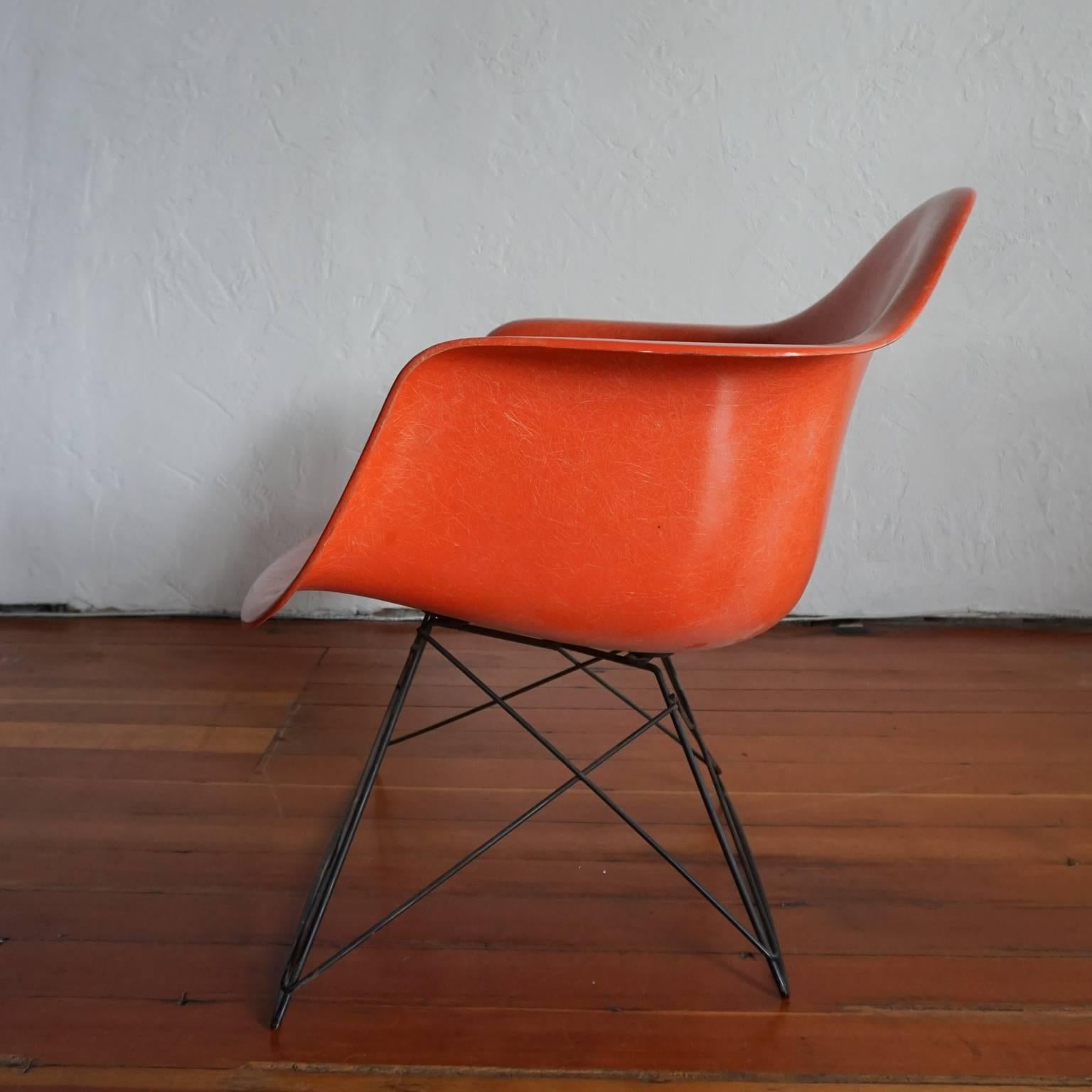 All original vintage fiberglass LAR by Charles and Ray Eames for Herman Miller, 1950s. The color is a red-orange.