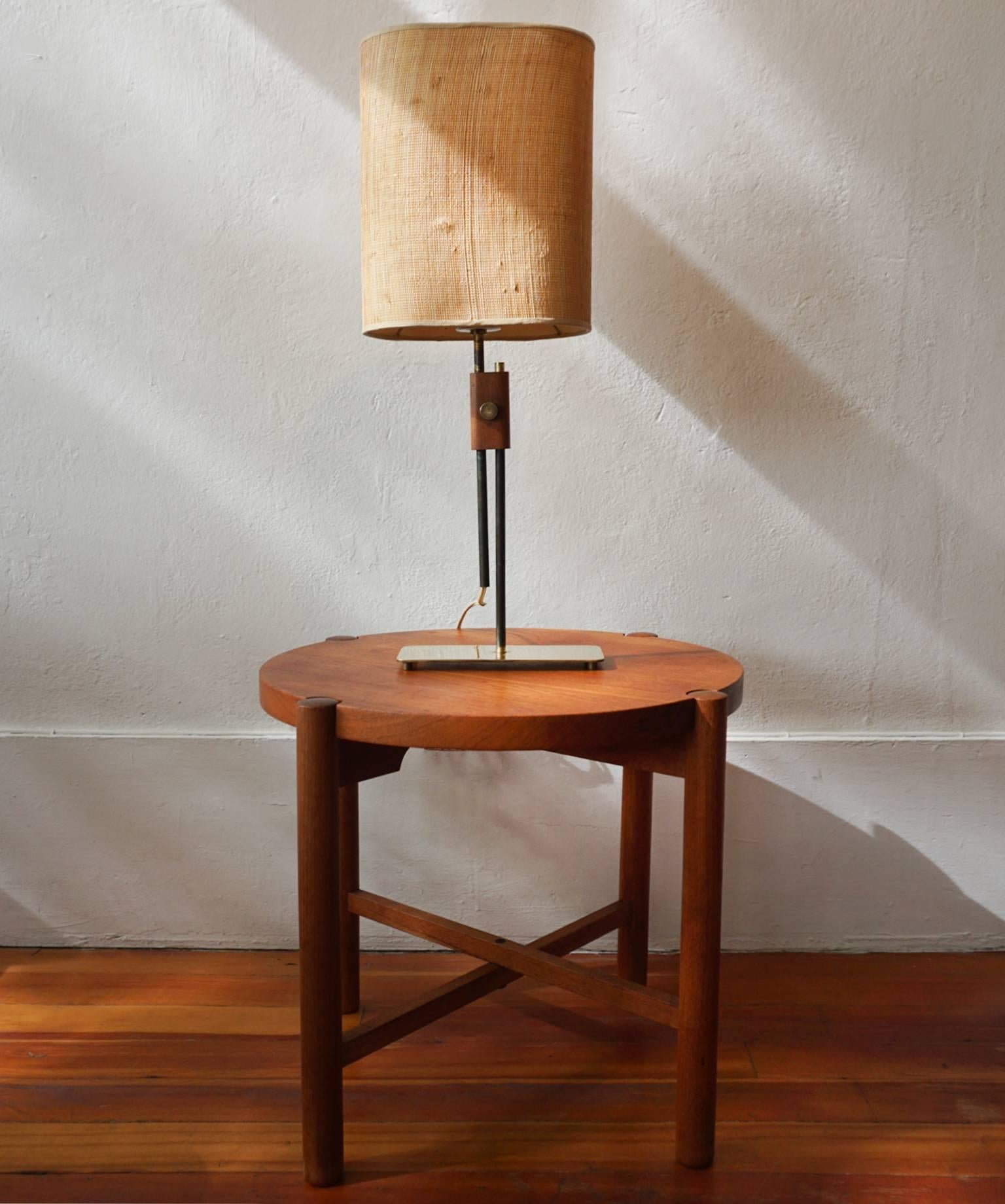 Solid brass adjustable height brass lamp with original shade.

The lamp adjusts from 23